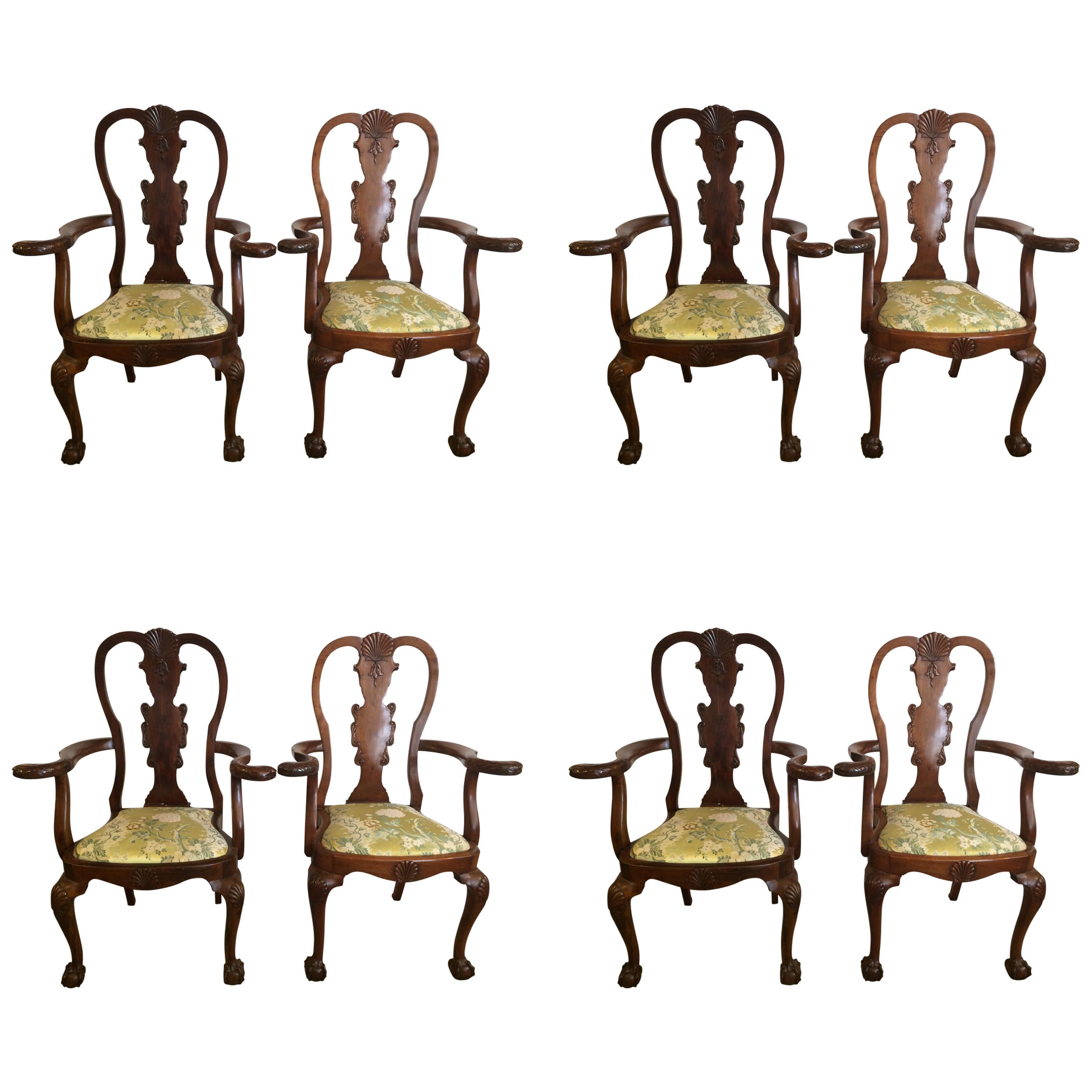 A wonderful antique set of mahogany Queen Anne style dining chairs with charm and character having two arm chairs and six side chairs. The arm chairs have curved arms with serpents as handle, all have shell motif decoration and ball and claw