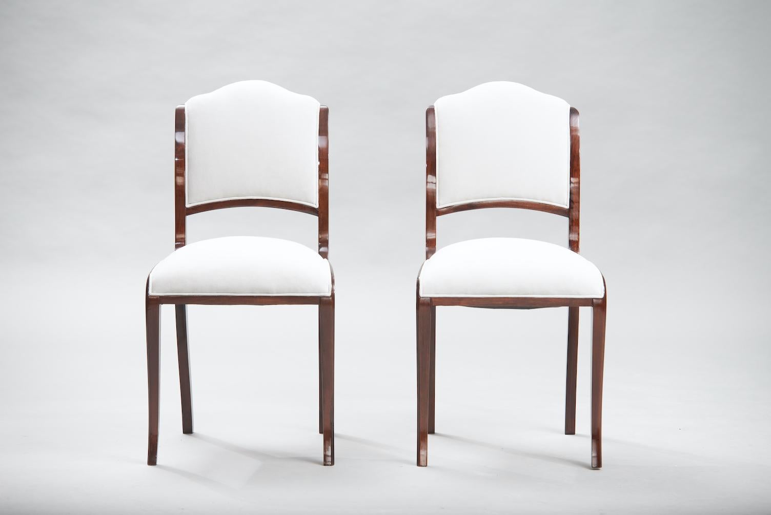 Set of eight walnut french art deco dining chairs reupholstered in ivory fabric.