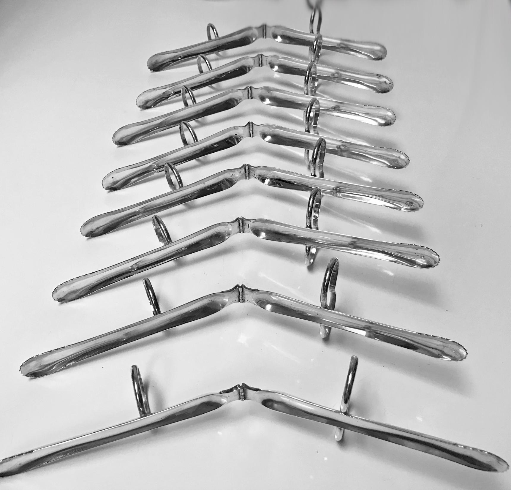 Set of eight 800 silver Art Deco individual asparagus tongs servers, circa 1920. Each of plain design, fingers and thumb ring grips. Each stamped 800. Measure length: 4.75 inches. (not extended). Total item weight: 356 grams.