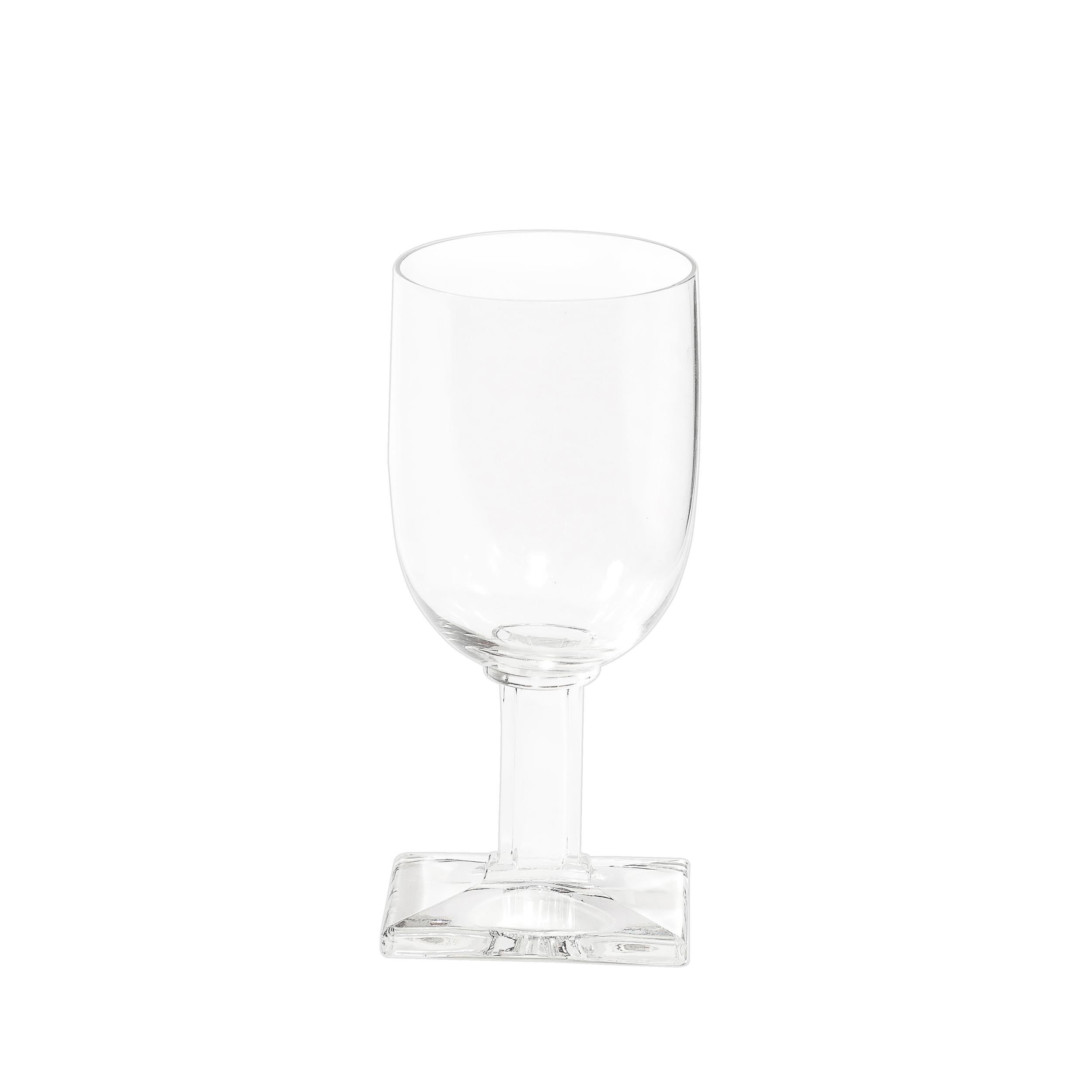 This striking set of eight Art Deco stemmed drinking glasses skillfully embodies the bold geometric elegance characteristic of the Art Deco movement. Crafted in America during the 20th century, each glass features a unique rectangular base, offering