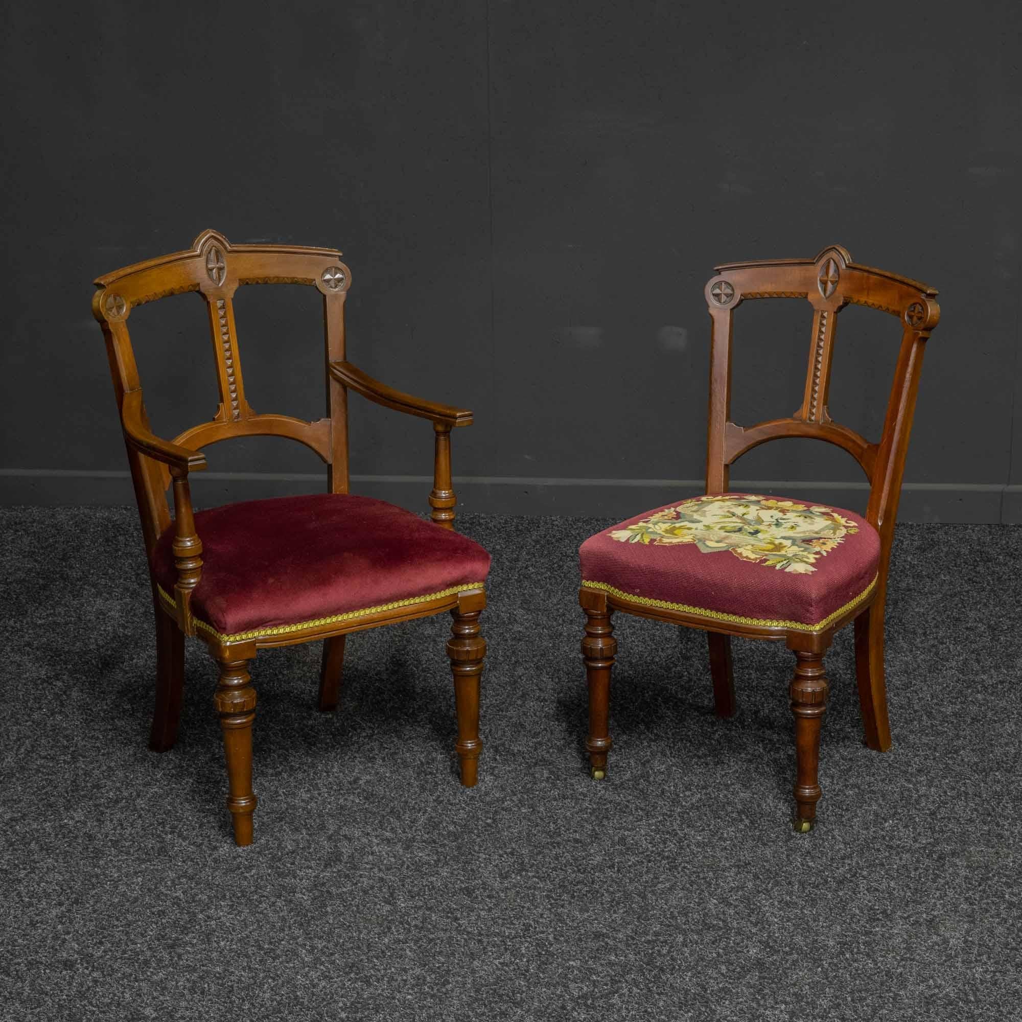 An unusual set of eight (two carvers and six singles) mahogany dining chairs with strong Arts & Crafts overtones within their design. The legs are turned with brass castors to the front on the singles. The single chairs also have their original