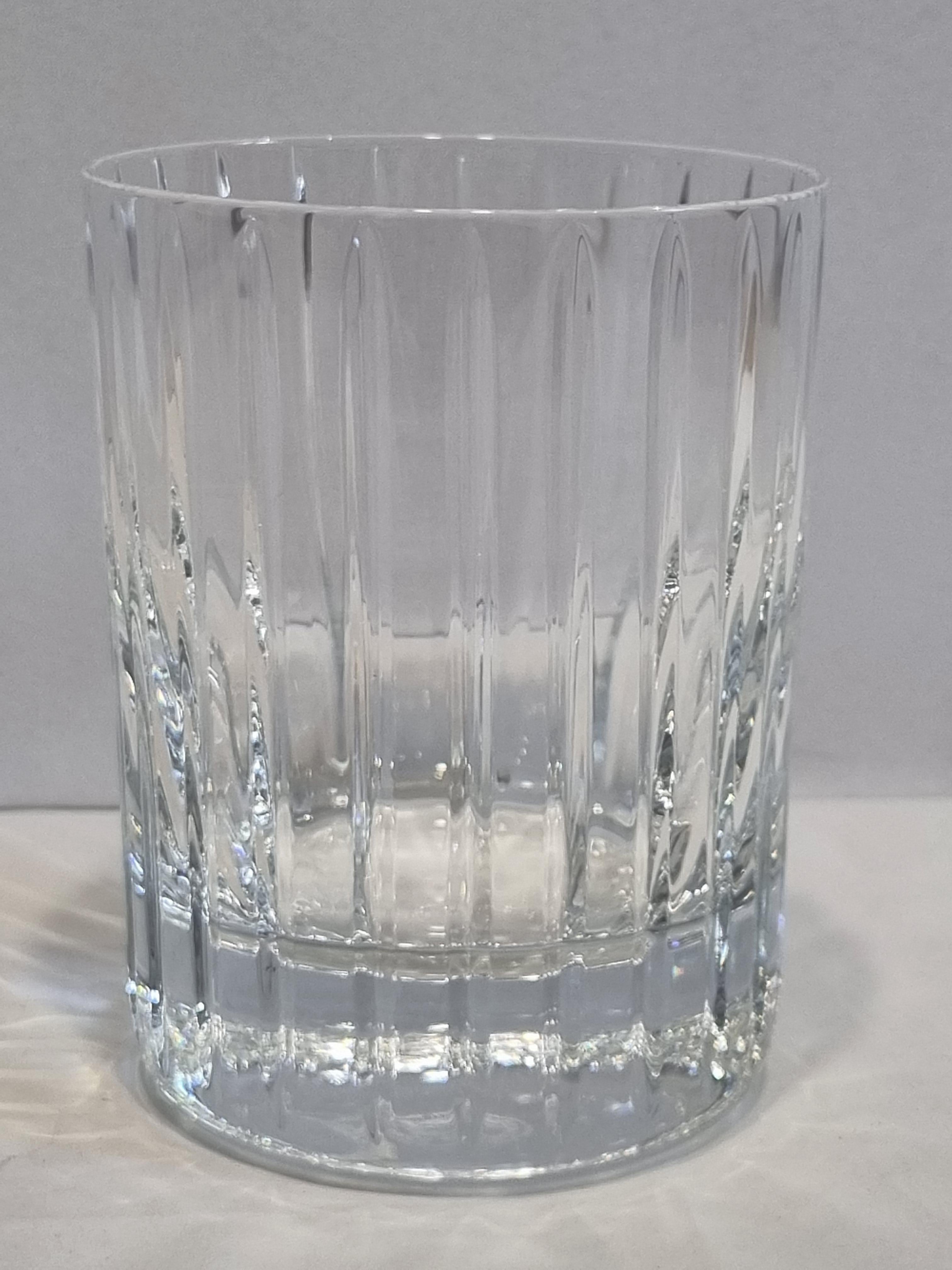 The Baccarat Clear crystal Harmonie tumbler has a marvelously linear silhouette that would be ideal for any stocked bar.
Consecutive parallel cuts travel cleanly along the Clear crystal grazing the tumbler from its lip all the way down to its thick