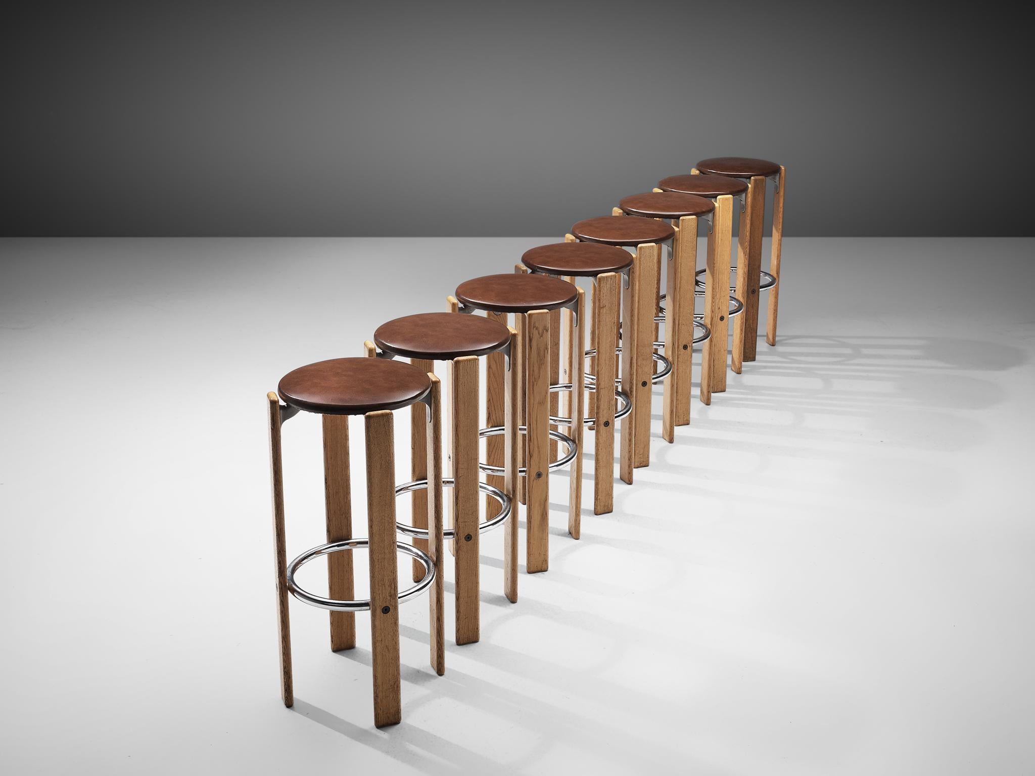 Bruno Rey for Dietiker, set of 8 bar stools, birch, leatherette and metal, Switzerland, 1970s.

This set of eight functionalist barstools is an iconic design by Bruno Rey. Characteristic steel brackets support the leatherette upholstered round