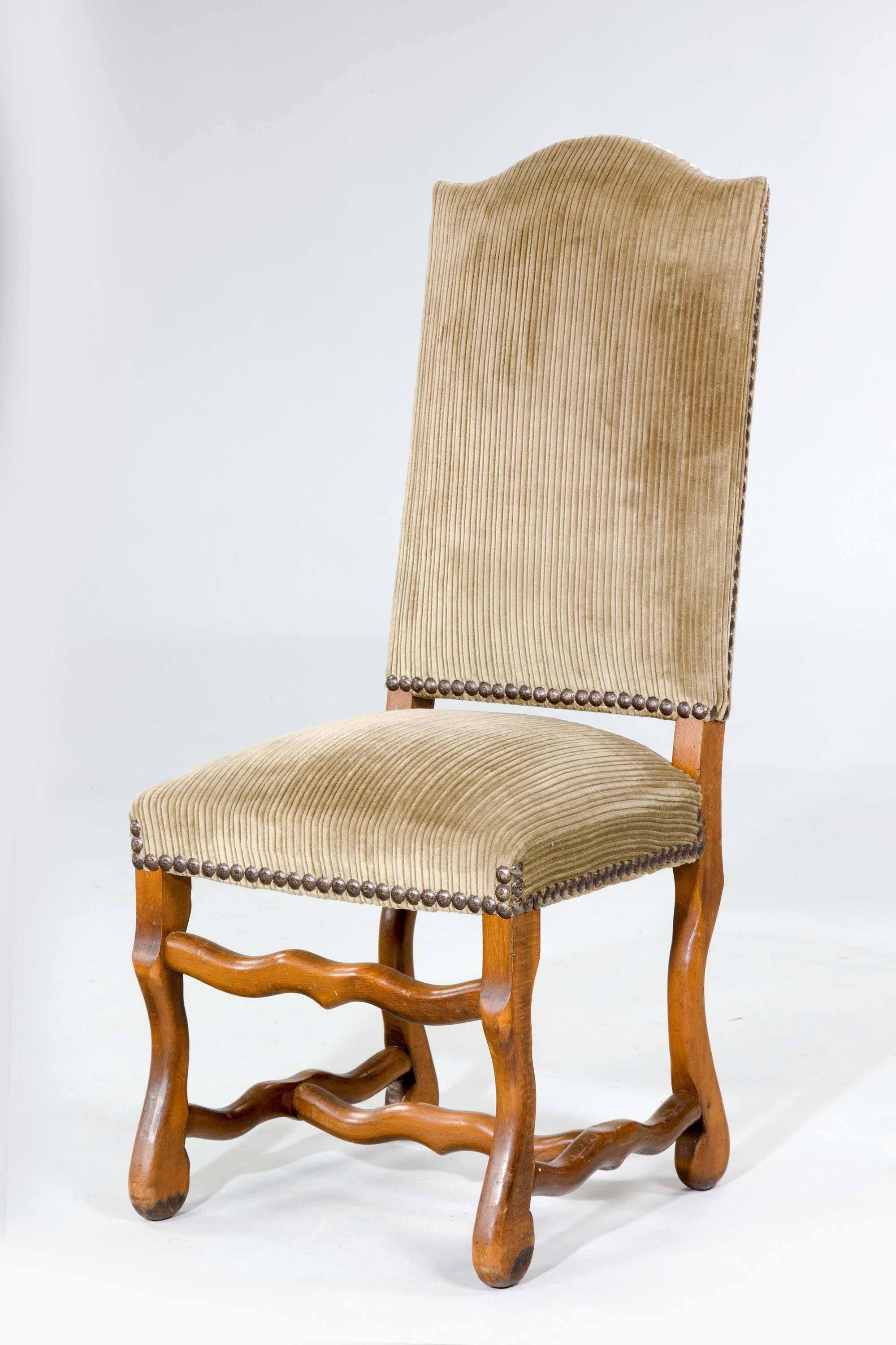 Set of eight beech continental dining room chairs on wavy front supports and with shaped stretchers in an attractive covering with French nails.