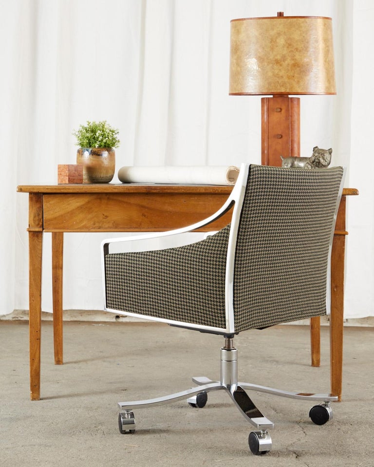 Amazing set of eight Mid-Century Modern office desk armchairs by Bert England for Stow Davis. These executive desk chairs feature a flat bar Milo Baughman style steel frame with a chrome like polished finish. The gracefully curved frames are