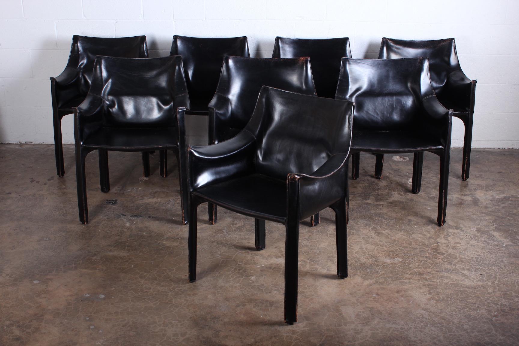 A vintage set of black leather cab armchairs with nice patina. Designed by Mario Bellini for Cassina.