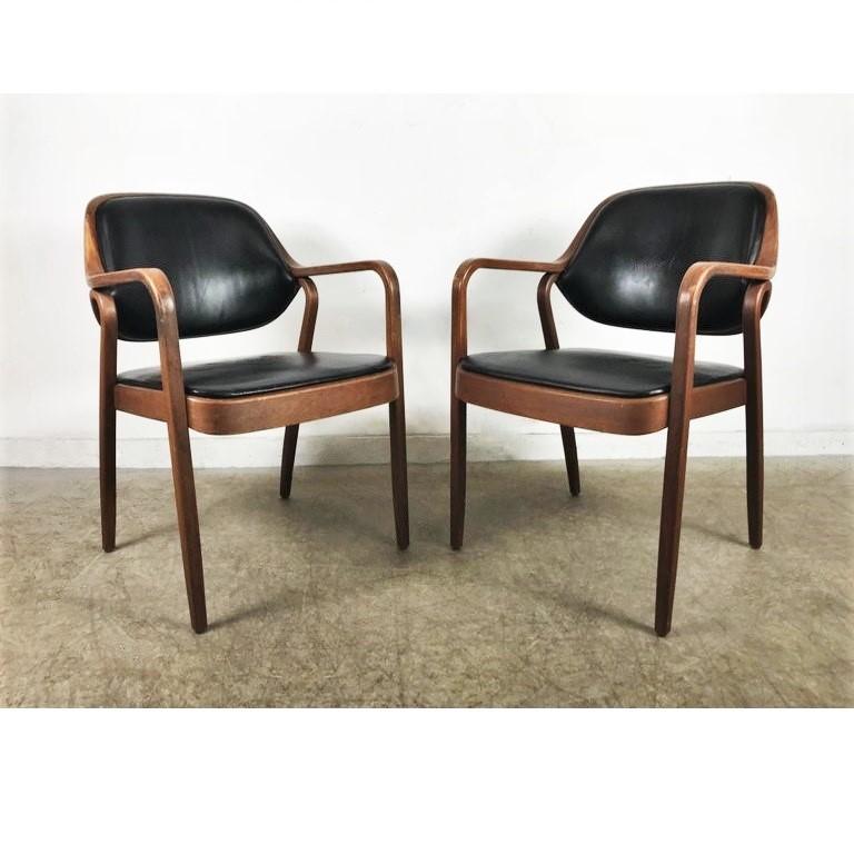 Set of eight black Don Petitt Bentwood armchairs for Knolla Bentwood armchairs by Don Petitt for Knoll. Two lengths of pressed and bent layers of sculpted wood make up the legs and arms as well as the seat back frames. Chairs feature black