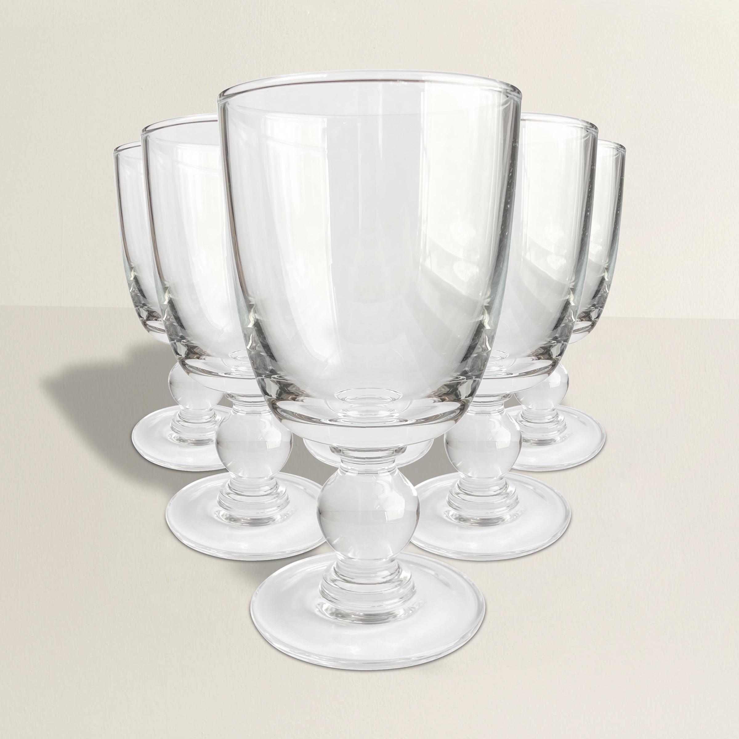 Elevate your dining experience with this exquisite set of 20th-century blown crystal goblets. Crafted with precision and care, these goblets are not just drinkware; they are a testament to the artistry of crystal blowing.

Each goblet features a