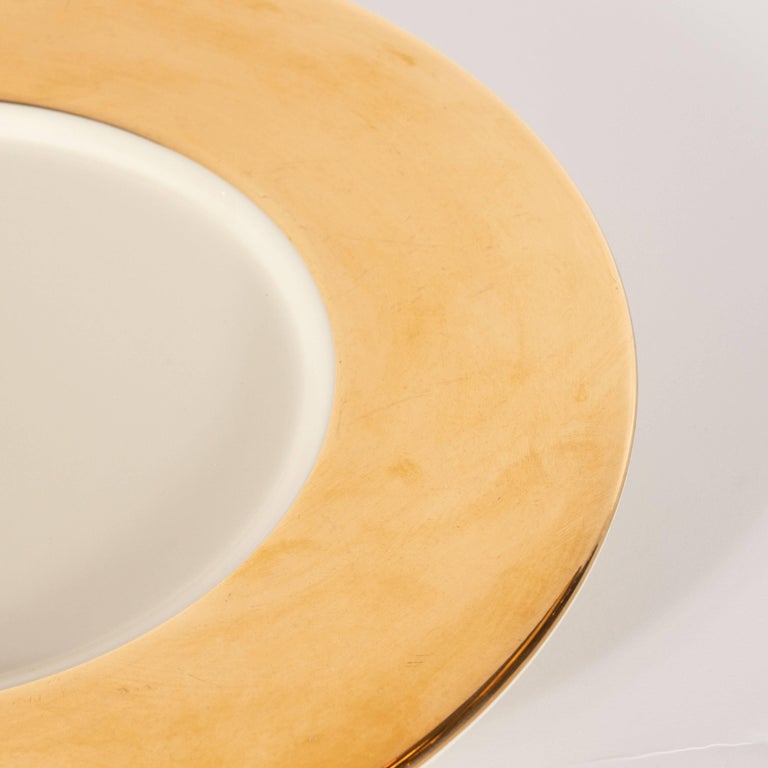 Set of Eight Bone Hue Porcelain and 24Karat Yellow Gold Charger Plates