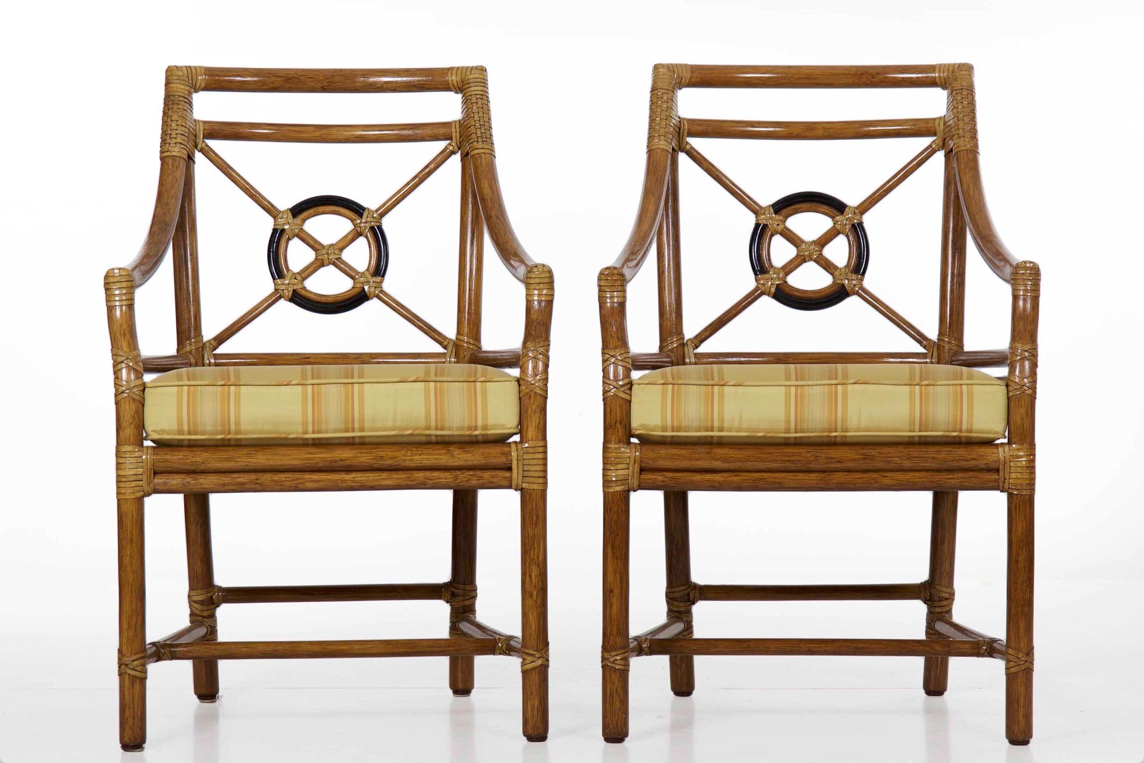 Vintage set of eight rattan dining armchairs
by McGuire of San Francisco, circa late 20th century.

This is a gorgeous set of eight rattan dining arm chairs retailed by McGuire in San Francisco during the last quarter of the 20th century. They