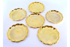 Set of eight bread plates in gilded silver with engraved plant motifs