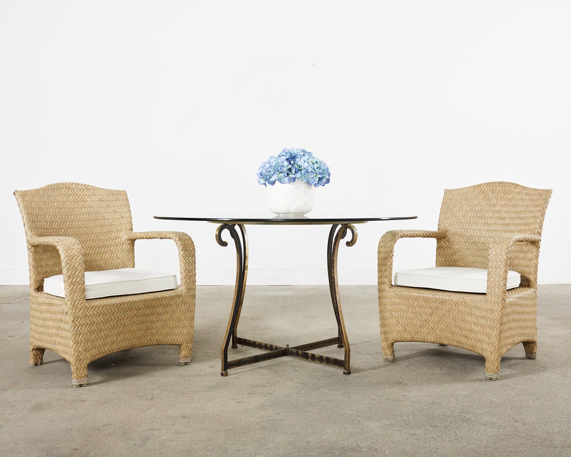 Rare set of eight large patio and garden dining armchairs from the Havana Collection by Brown Jordan. The set features sturdy aluminum frames wrapped with woven resin wicker in stylish earth-toned shades. The chairs have a humped crest back