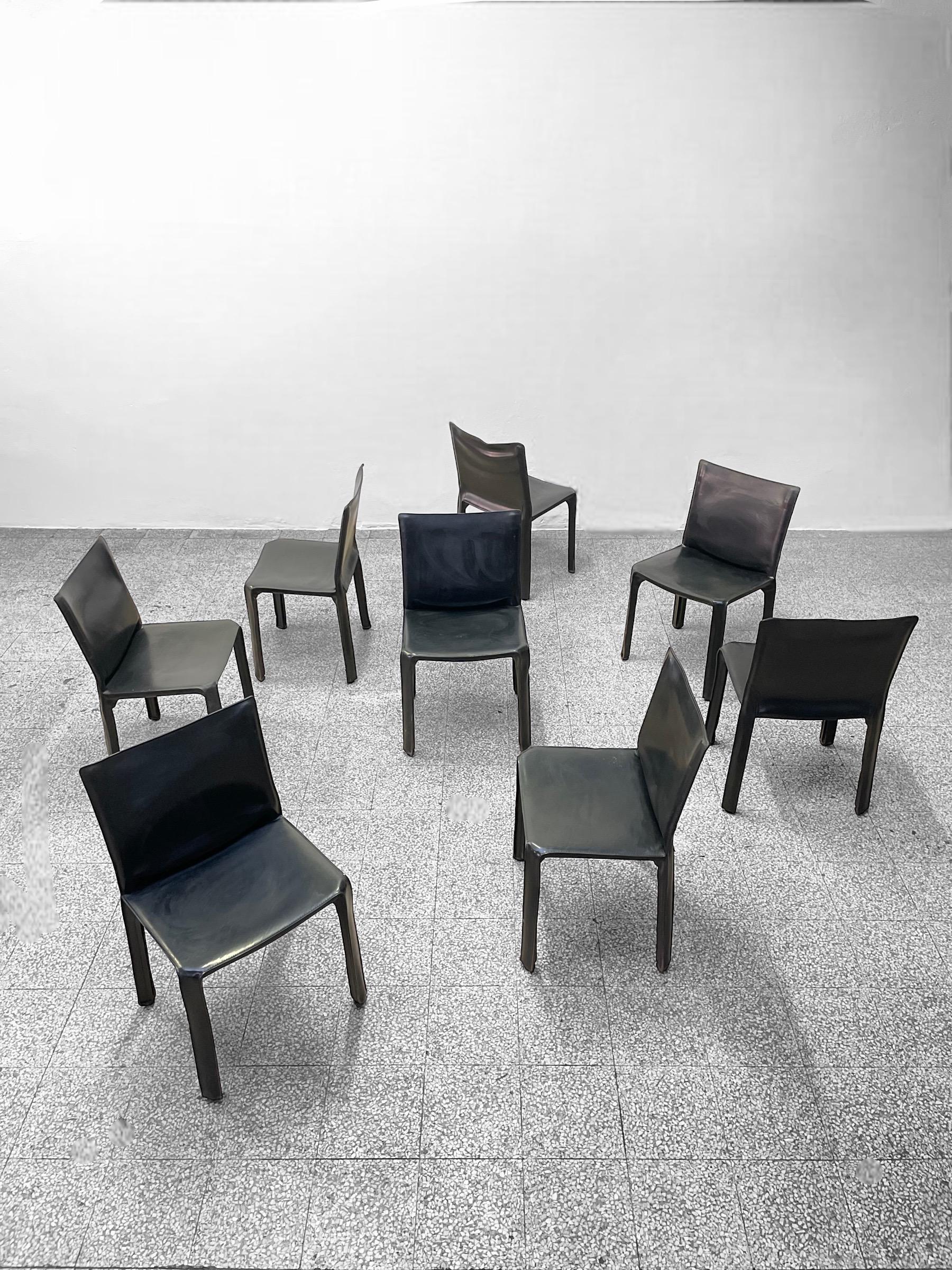 A set of eight Italian design icons in black saddle leather.

When first produced in 1977, the CAB was the first chair to feature a free-standing leather structure, inspired by how human skin fits over our skeleton. The leather upholstery is