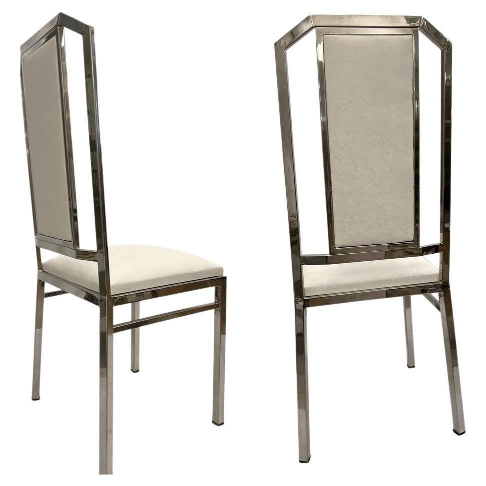 Set of eight chairs in chromed metal, back and seat upholstered with foam and recently covered with cream colored skai.