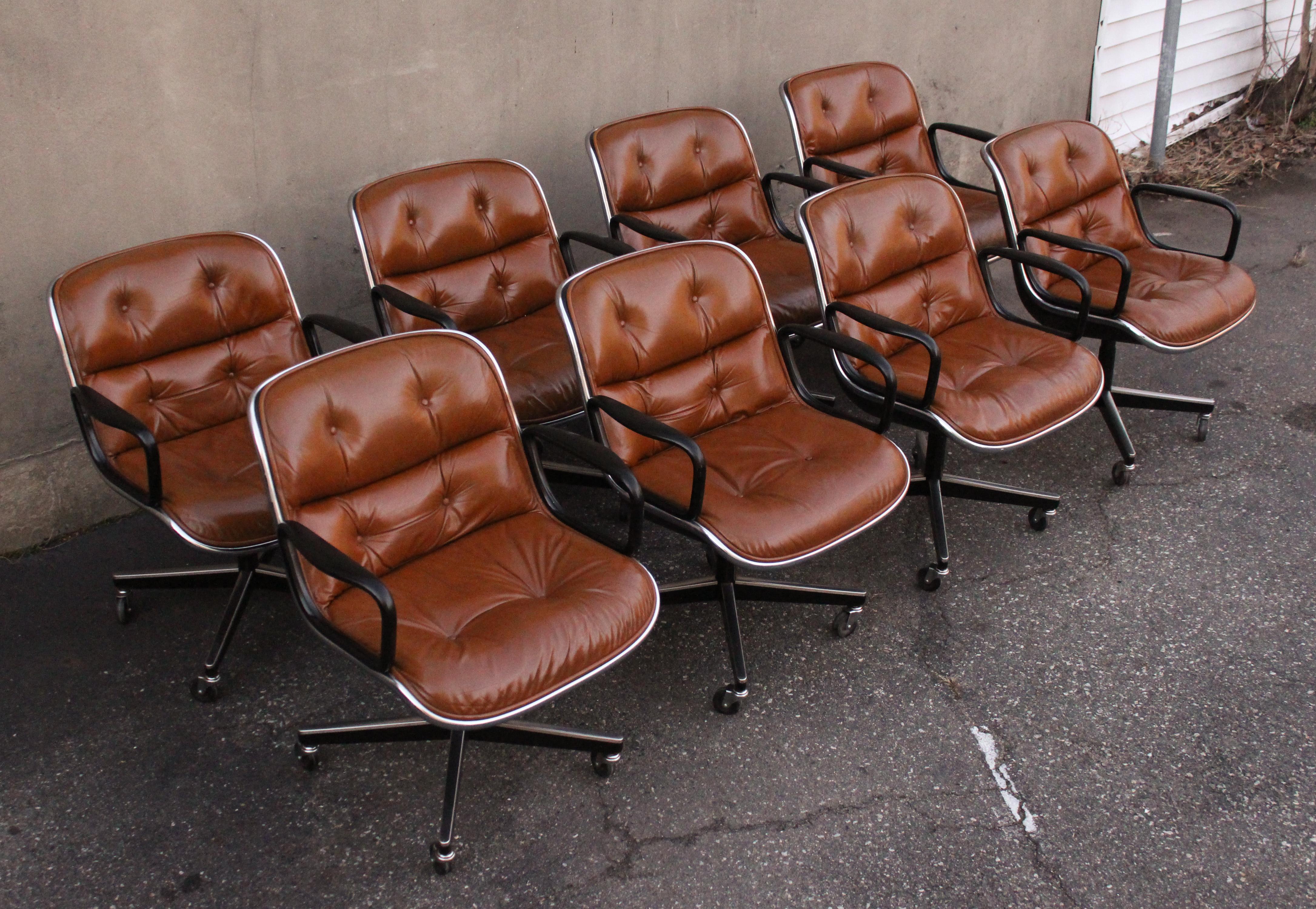Comfortable executive desk chairs designed by Charles Pollock and manufactured by Knoll International, United States. These desk chairs are made of high quality medium brown leather, have chrome plated legs and footrests and plastic arms. The