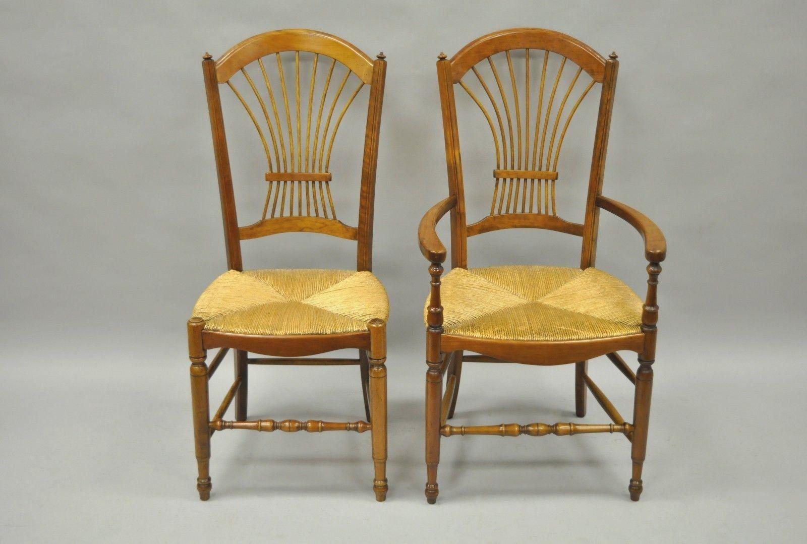 Set of eight cheerywood wheat sheaf back rush seat dining chairs. Item details two armchairs, six side chairs, solid wood construction, beautiful wood-grain, wheat sheaf backs, woven rush seats, distressed finish, circa late 20th-early 21st century.
