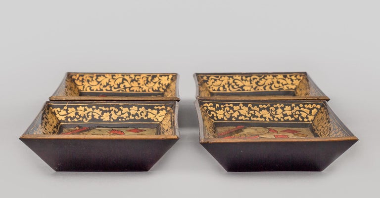 Set of eight Chinese Export Canton very small lacquered trays. Four depict the king and queen in red and gilded costumes against a black background; four depict figures in palace scenes with pagodas against a gilded and black background.