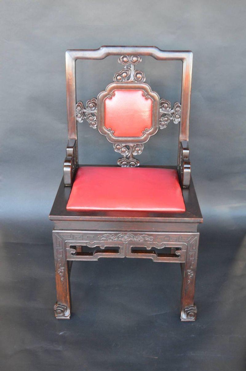 Set of eight Chinese chairs with red leather backs and seats, hand carved mahogany wood.