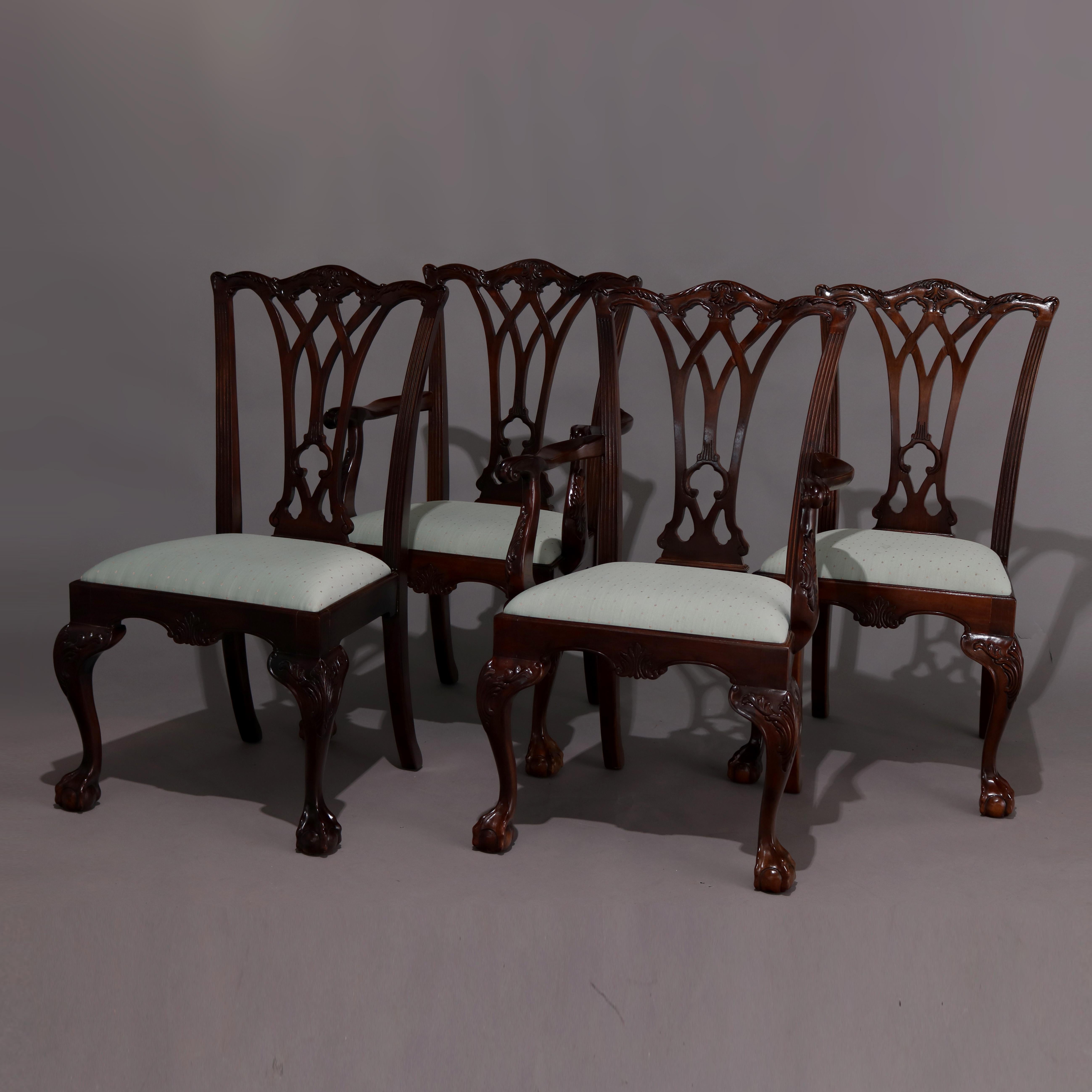 A set of eight Chippendale style Henredon Heritage dining chairs feature carved mahogany frames with ribbon backs surmounted by carved foliate crests, upholstered seats, shaped apron with central carved palmette, and raised on cabriole legs having