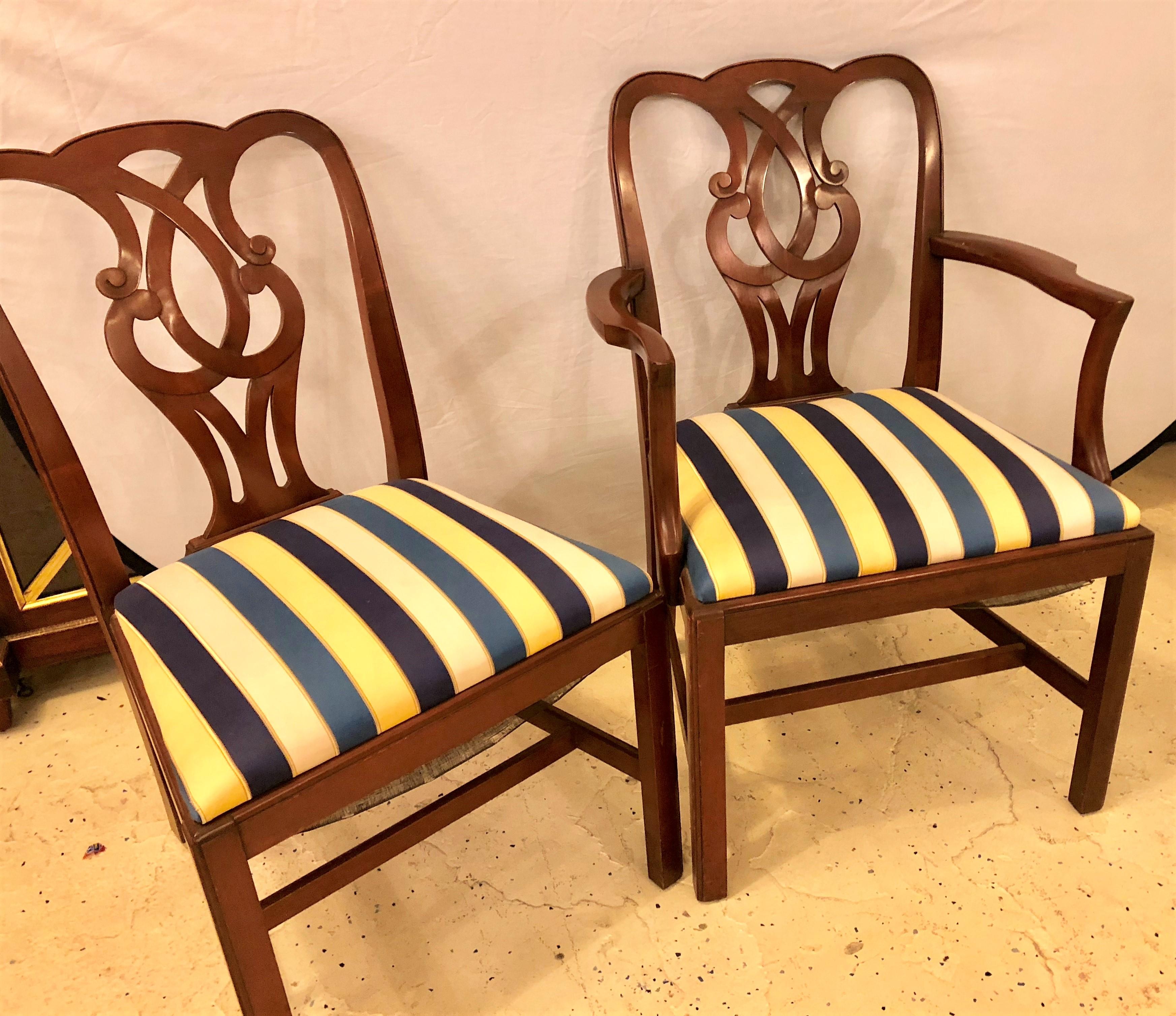 Set of eight Chippendale style Baker Pretzel back dining chairs. Two-arm chairs and six side chairs make up this fine set of solid mahogany dining chairs. Each with a curved crest rail over an open pierced splat above a trapezoidal seat resting on