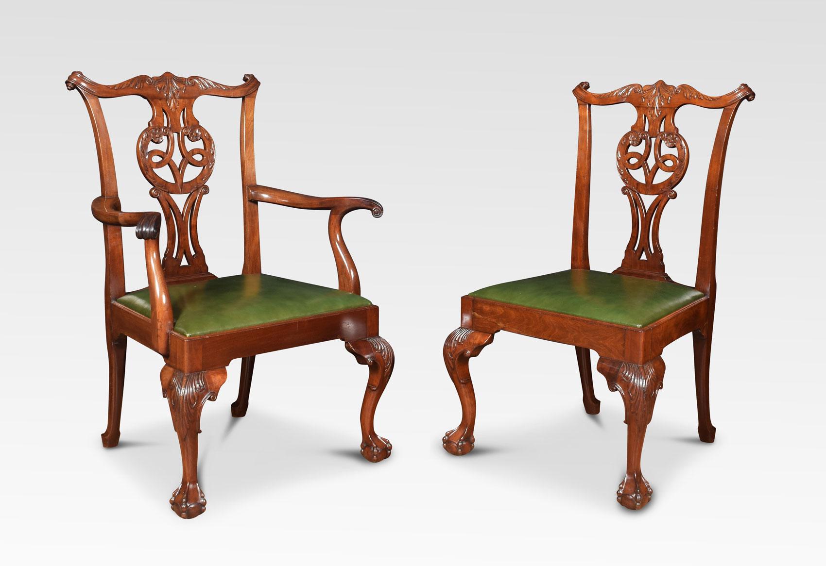 Set of eight mahogany dining chairs, the set consisting of two carvers and six single chairs. Each with yoked crest rail above a pierced splat with quatrefoil cut-outs over a drop-in green leather seat. All raised up on cabriole supports terminating
