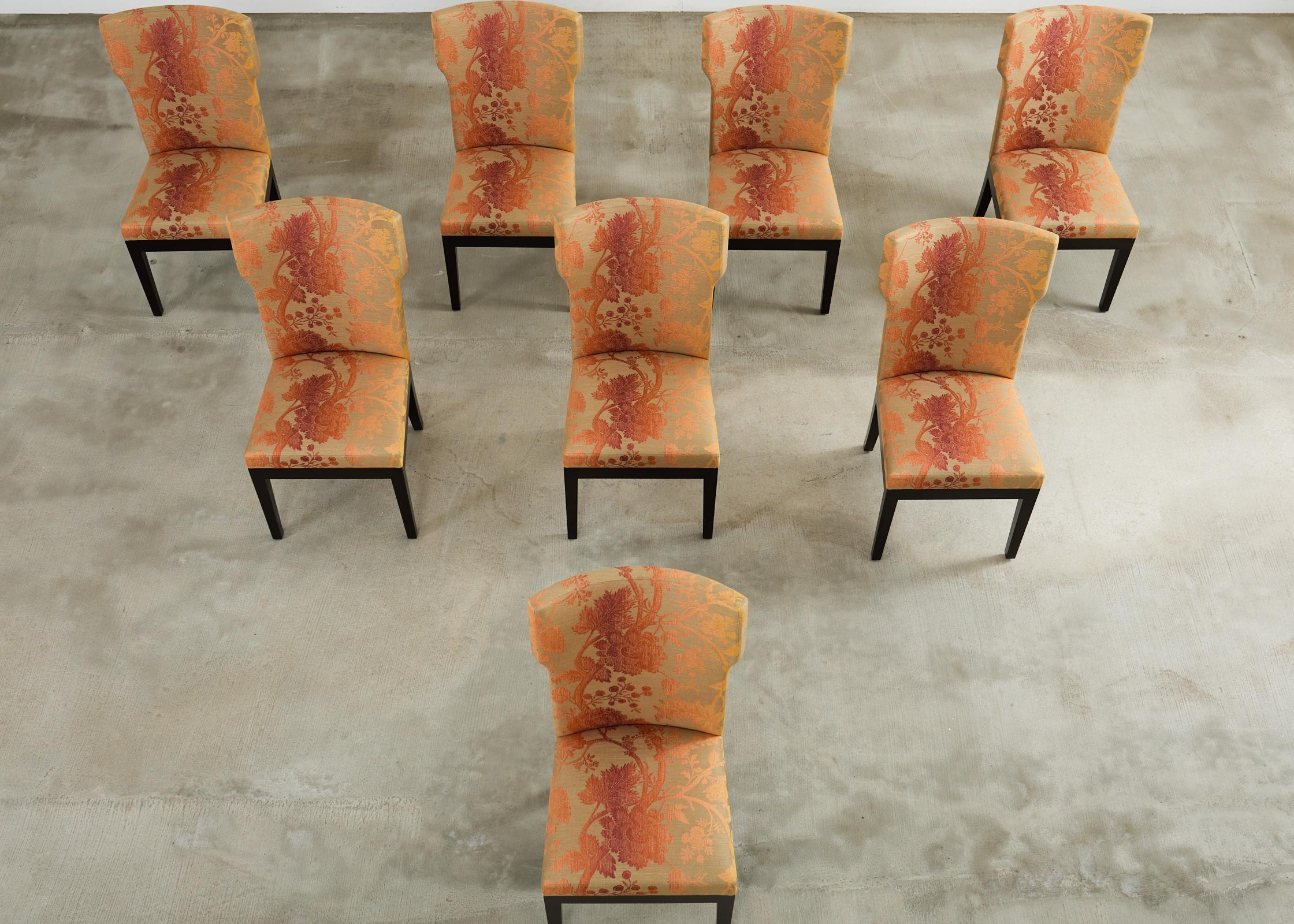 Fantastic set of eight bespoke Barbuda dining chairs designed by Christian Liaigre for Holly Hunt. The labeled Barbuda chairs have a distinctive oak hardwood frame having a gracefully curved back and subtle wings. Finished in a brushed black