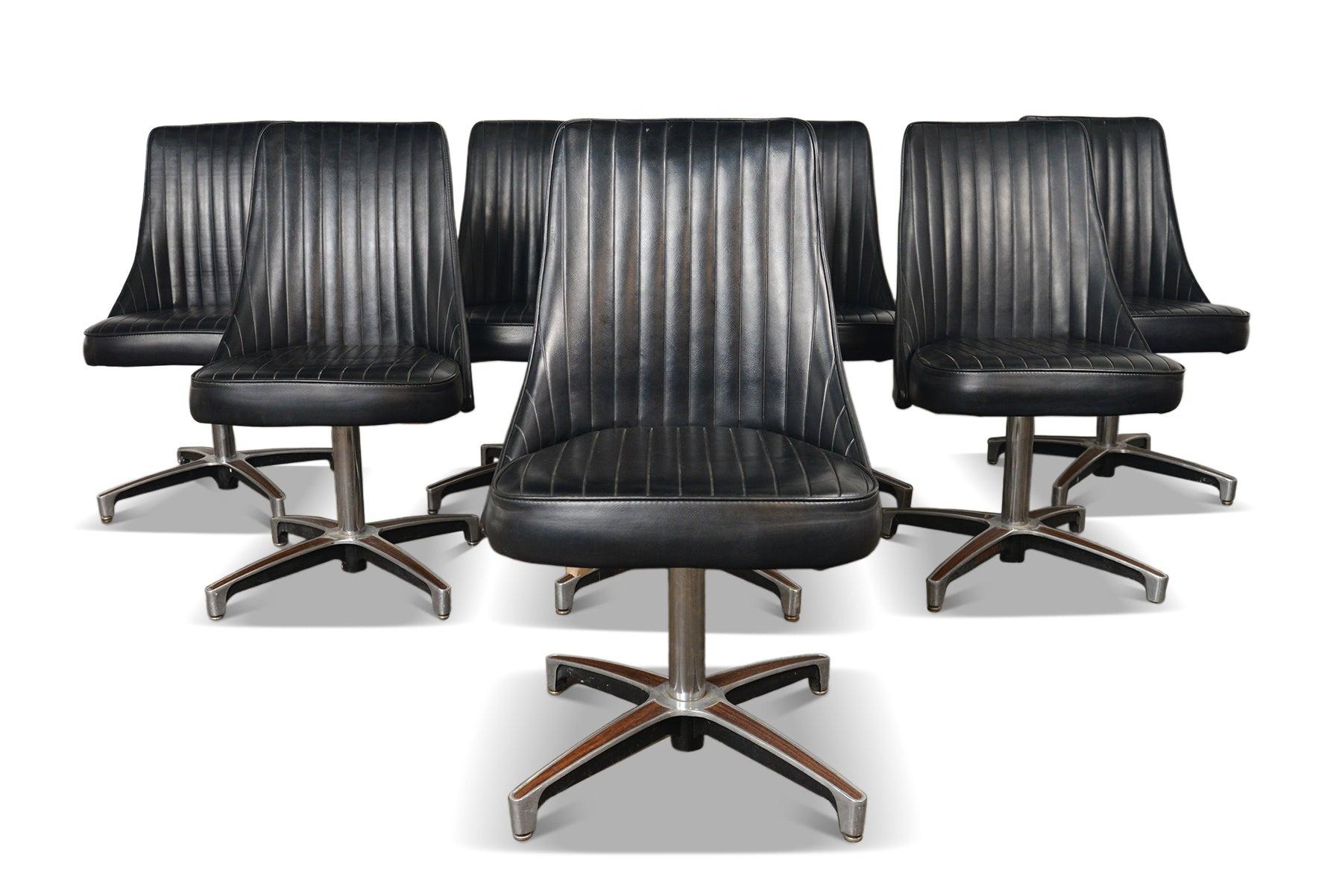 Set of period perfect 1960s Chromcraft lounge chairs.  This set wears its original black vinyl, with seats raised on cast aluminum swivel bases with walnut laminate inlays. 

These were purchased new in 1967 by the Oakland City of Commerce and have