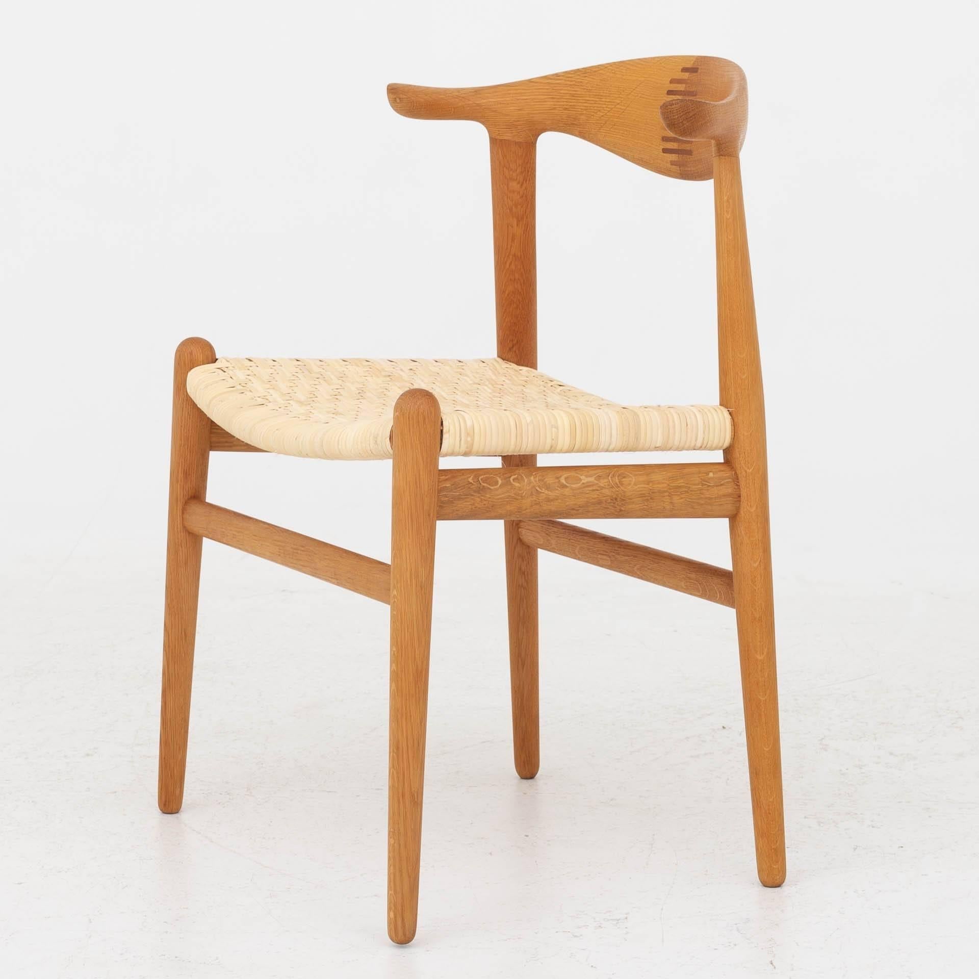 JH 505, cow horn chairs in oak and new cane. Designed in 1952.