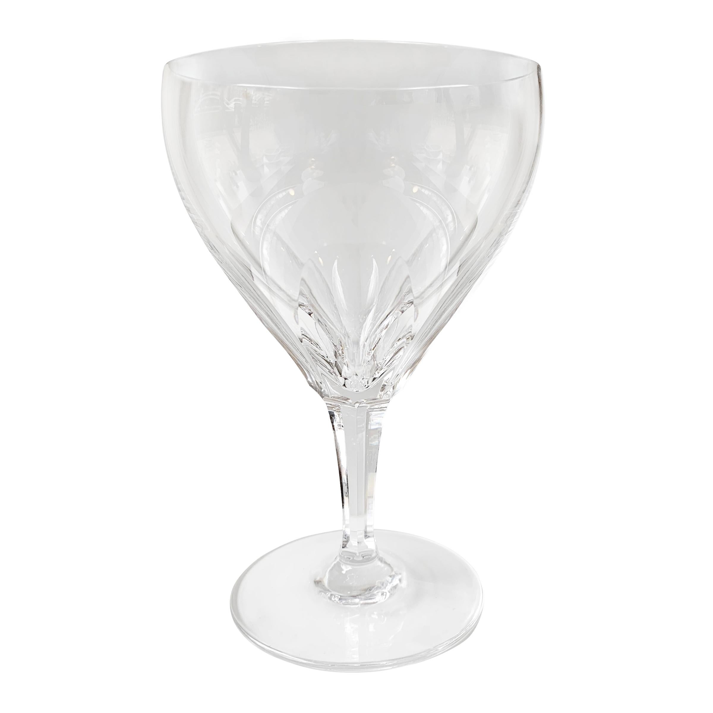 A set of eight cut crystal wine goblets manufactured by the German crystal company, Josair, in 1964. The sides feature six long panels cuts giving the appearance of a flower when looking down into the glass. Panel cutting is the most difficult type
