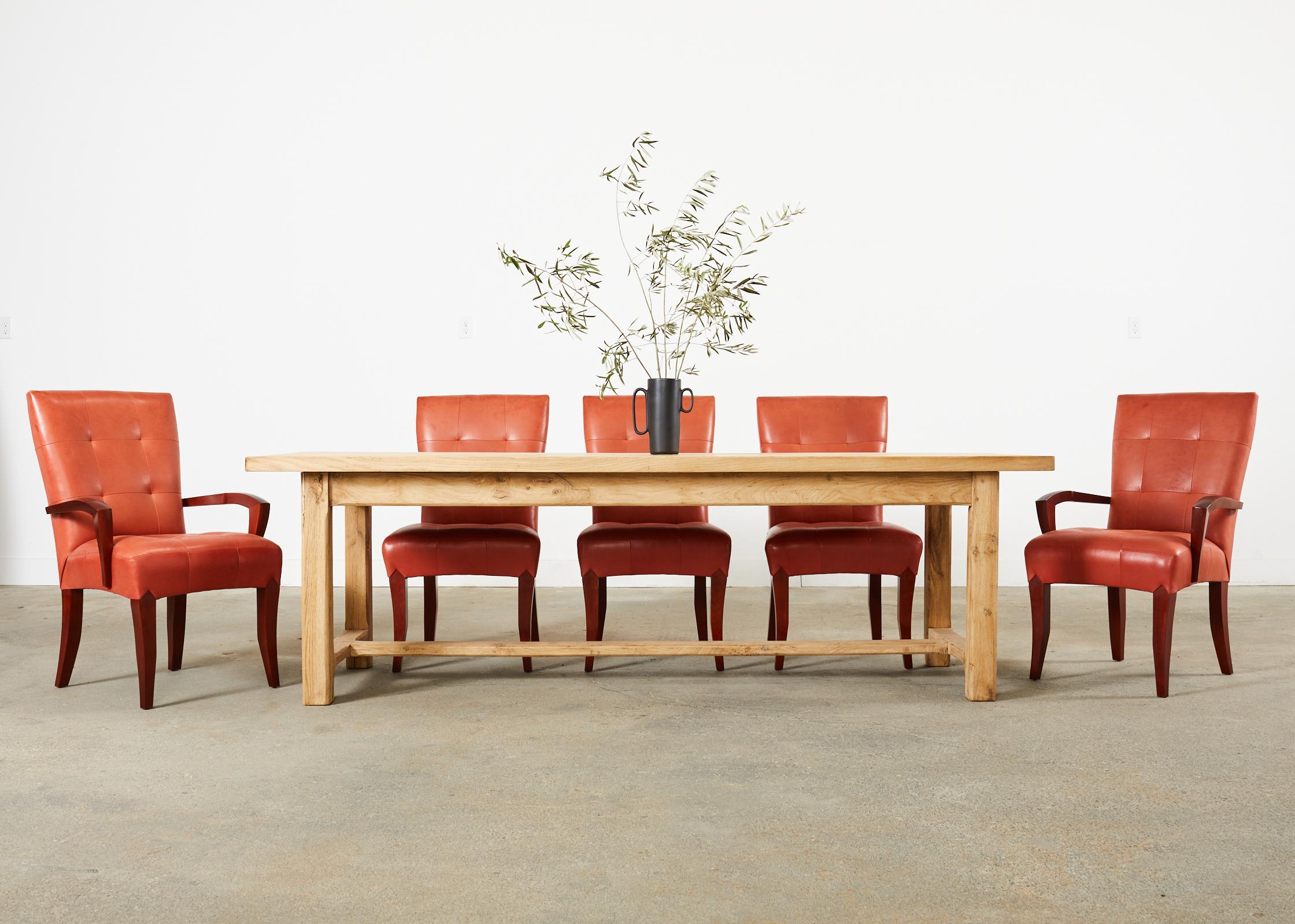 Matched set of eight dining chairs designed by Dakota Jackson. The set consists of six side chairs and two host armchairs with the arms measuring 24 inches wide and 25 inches high. Crafted from solid cherry frames and upholstered with a persimmon or