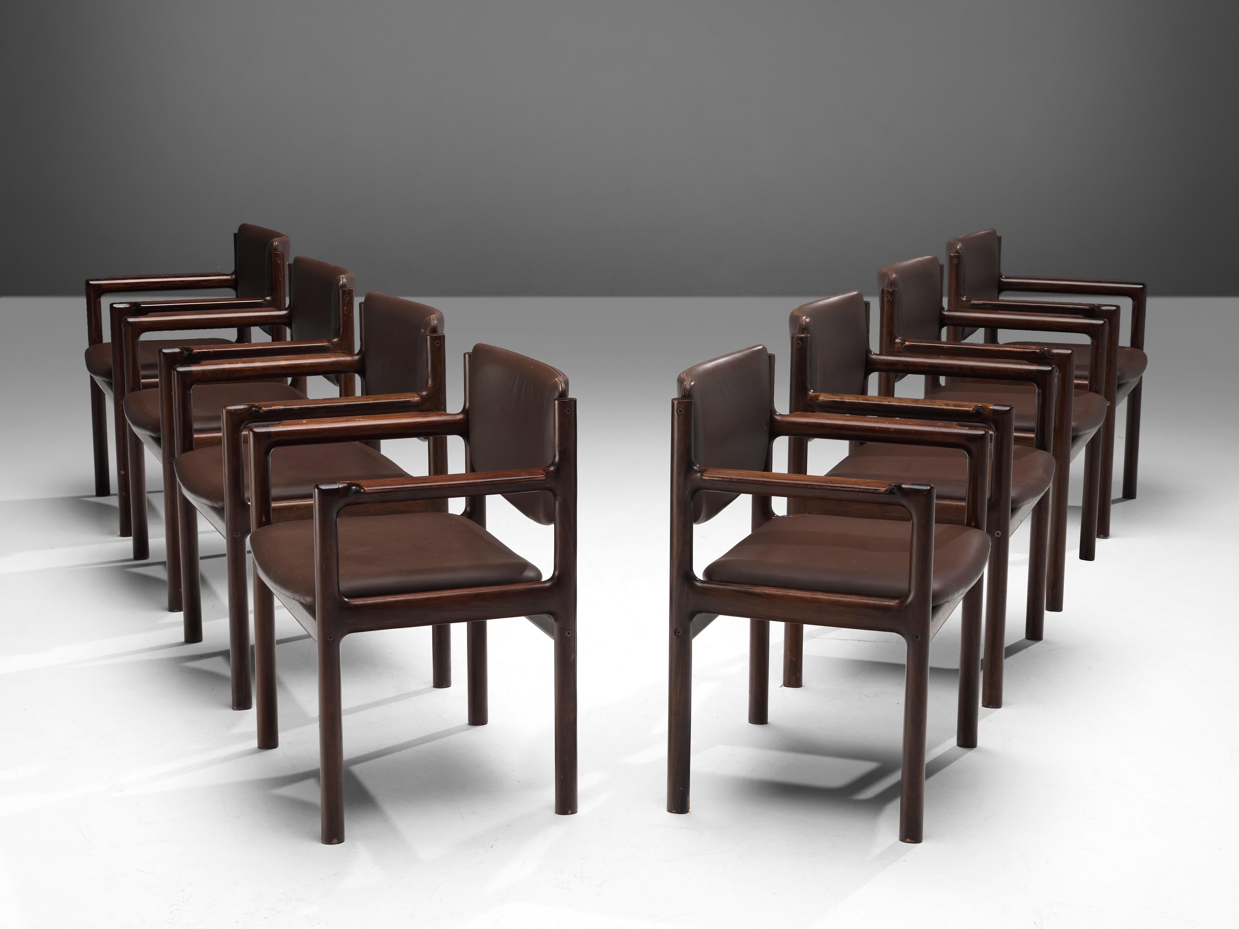 Set of eight armchairs, stained mahogany, leatherette, Denmark, 1960s.

The model of these chairs is angular and modest as it is build up in mainly horizontal and vertical lines. The clear, angular shapes are giving these chairs a strong appearance.