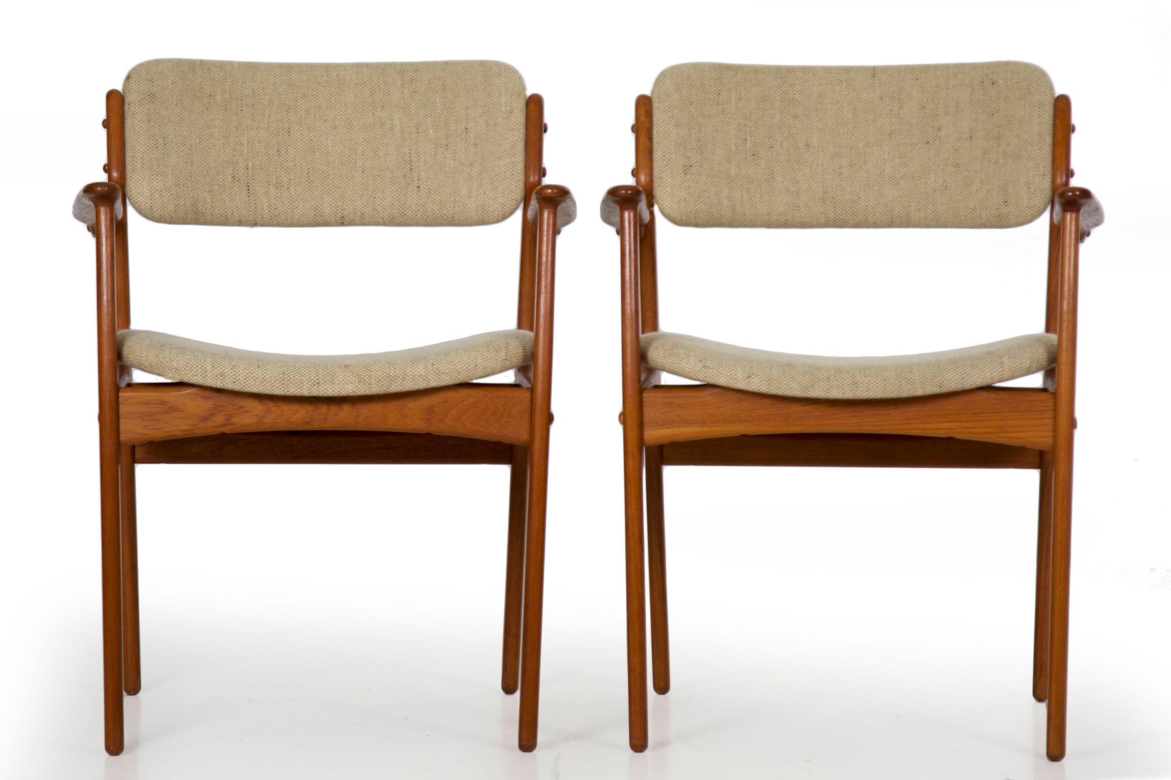 This excellent set of sculpted teak dining chairs were designed by Erik Buch for Oddense Maskinsinedkeri as Model 49. The set is composed of two arm chairs and six side chairs with curved and canted chair backs over floating seats. Each retains an