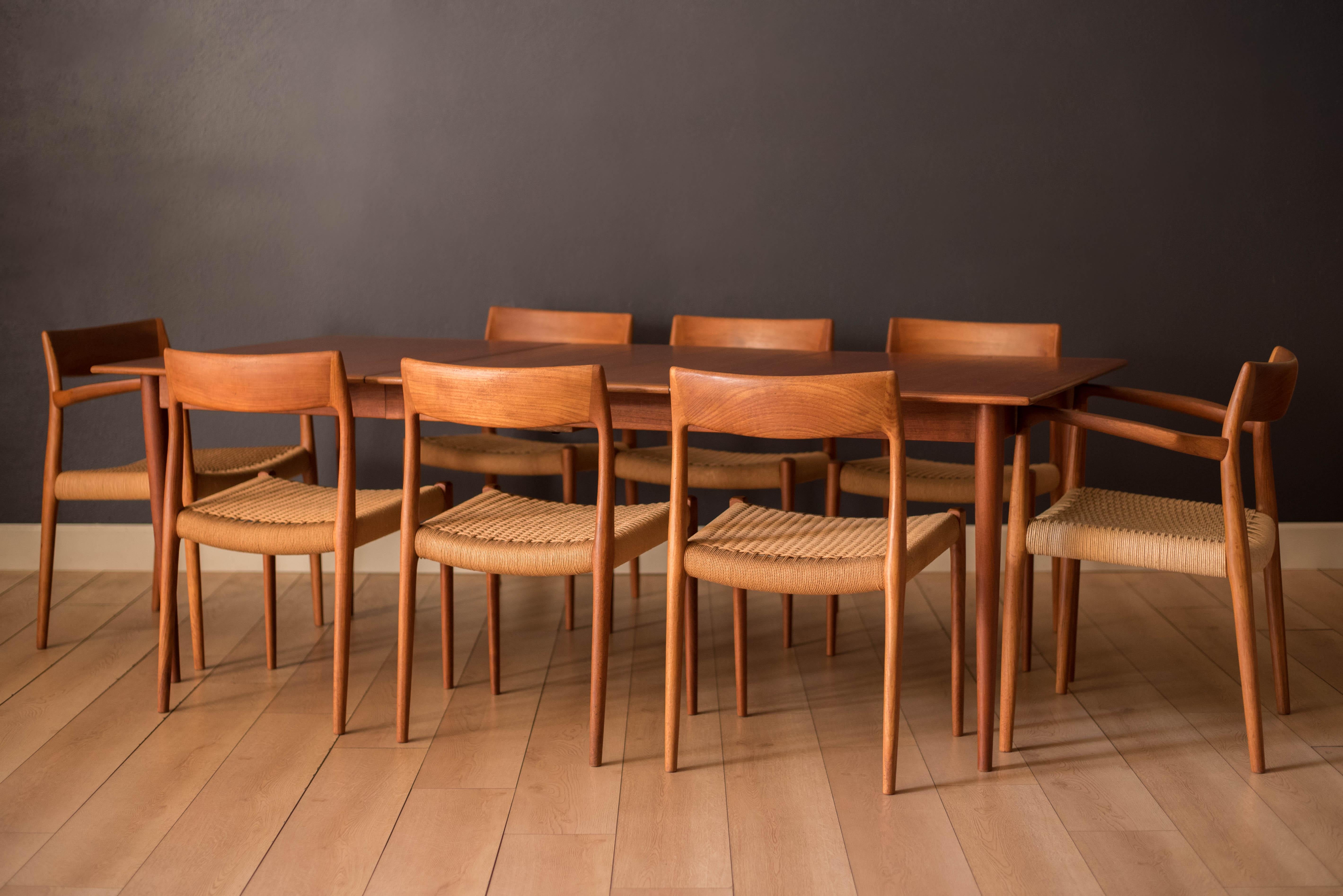 Mid-Century Modern dining chairs designed by Niels Otto Møller for J.L. Møller Møbelfabrik in teak, Denmark. This set includes six model no. 77 side chairs and two model no. 57 armchairs. Features natural woven paper cord seats and sculpted teak