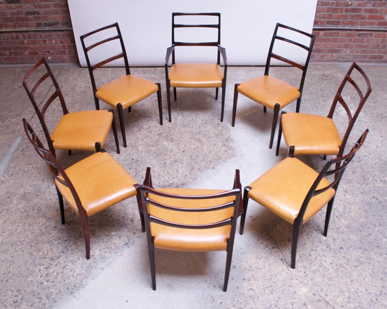 Impressive set of eight ladder-back dining chairs (six side, two captain) in rosewood attributed to Sorø Stolefabrik (circa 1960s, Denmark). From the luxe materials utilized to the exemplary craftsmanship / assembly, this exceptional set is of the