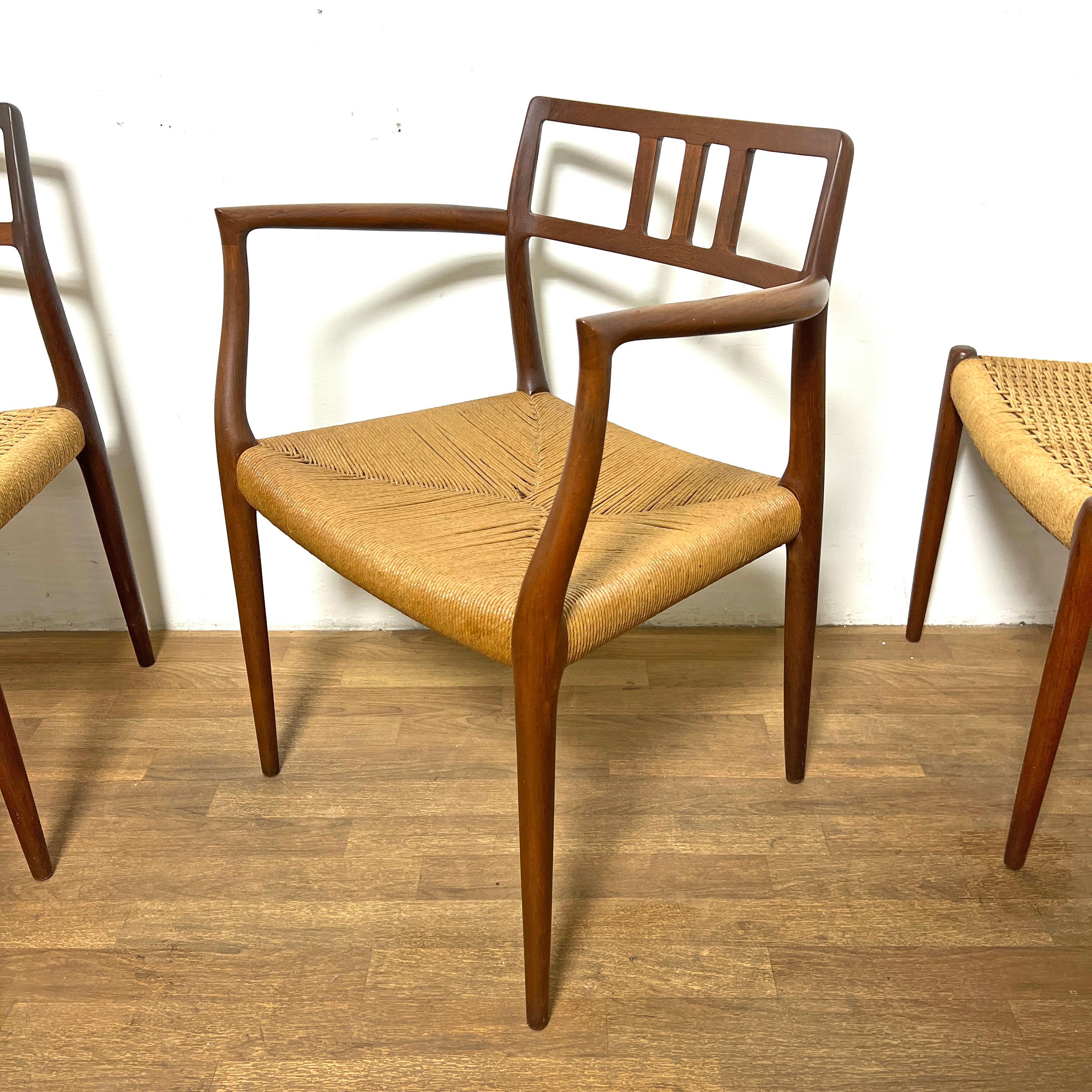 A set of eight fully restored Danish teak dining chairs by Niels Otto Moller for JL Moller, circa 1960s. The heirloom set includes six model #79 side chairs and a pair of #64 armchairs, all with richly patinated frames and paper cord seats.

Arm