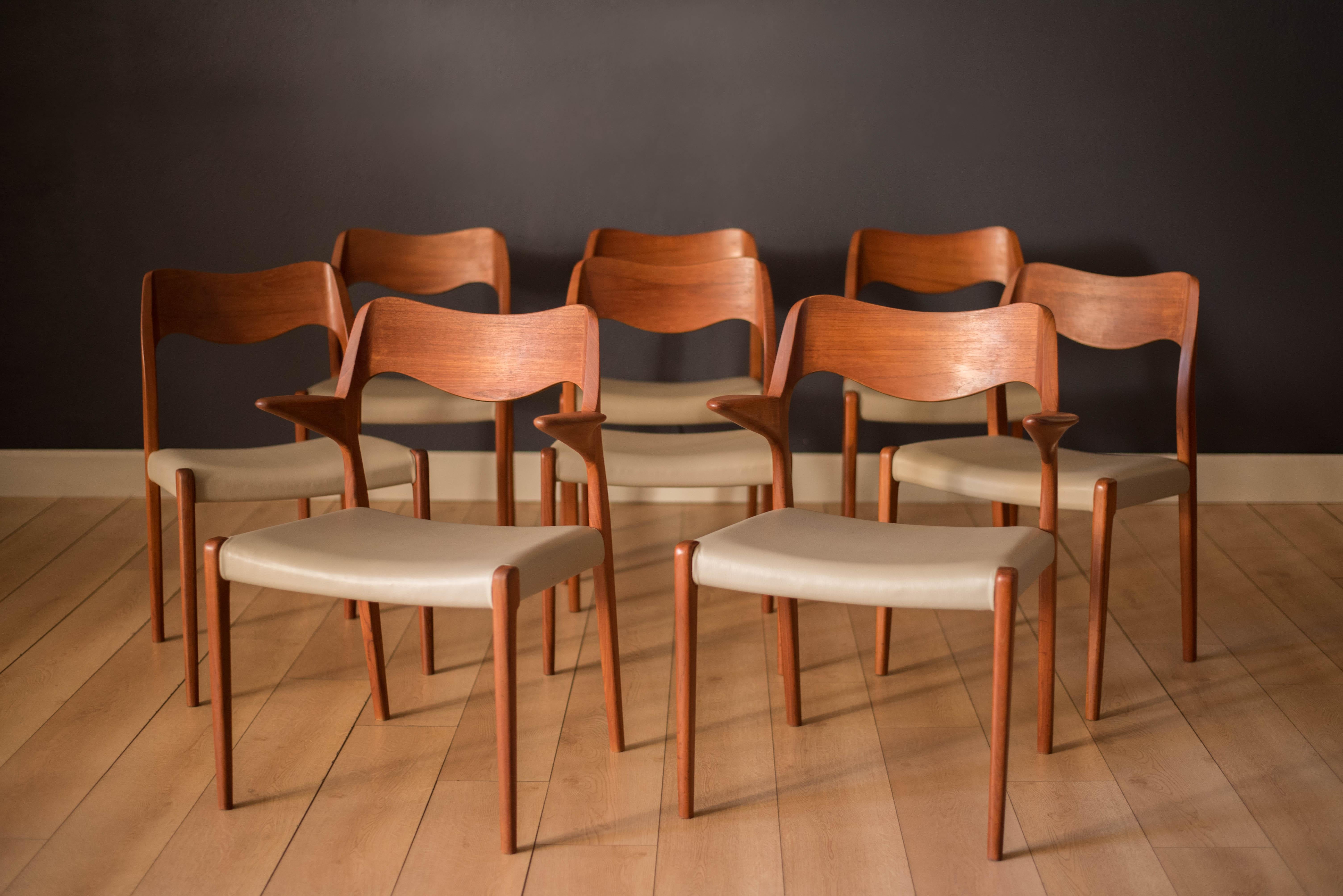 Midcentury set of eight Danish dining chairs by Niels Møller for J.L. Møller Møbelfabrik in teak. This set includes six model 71 side chairs and two 55 armchairs. The seats have been professionally reupholstered in a nude gray leatherette. Price is