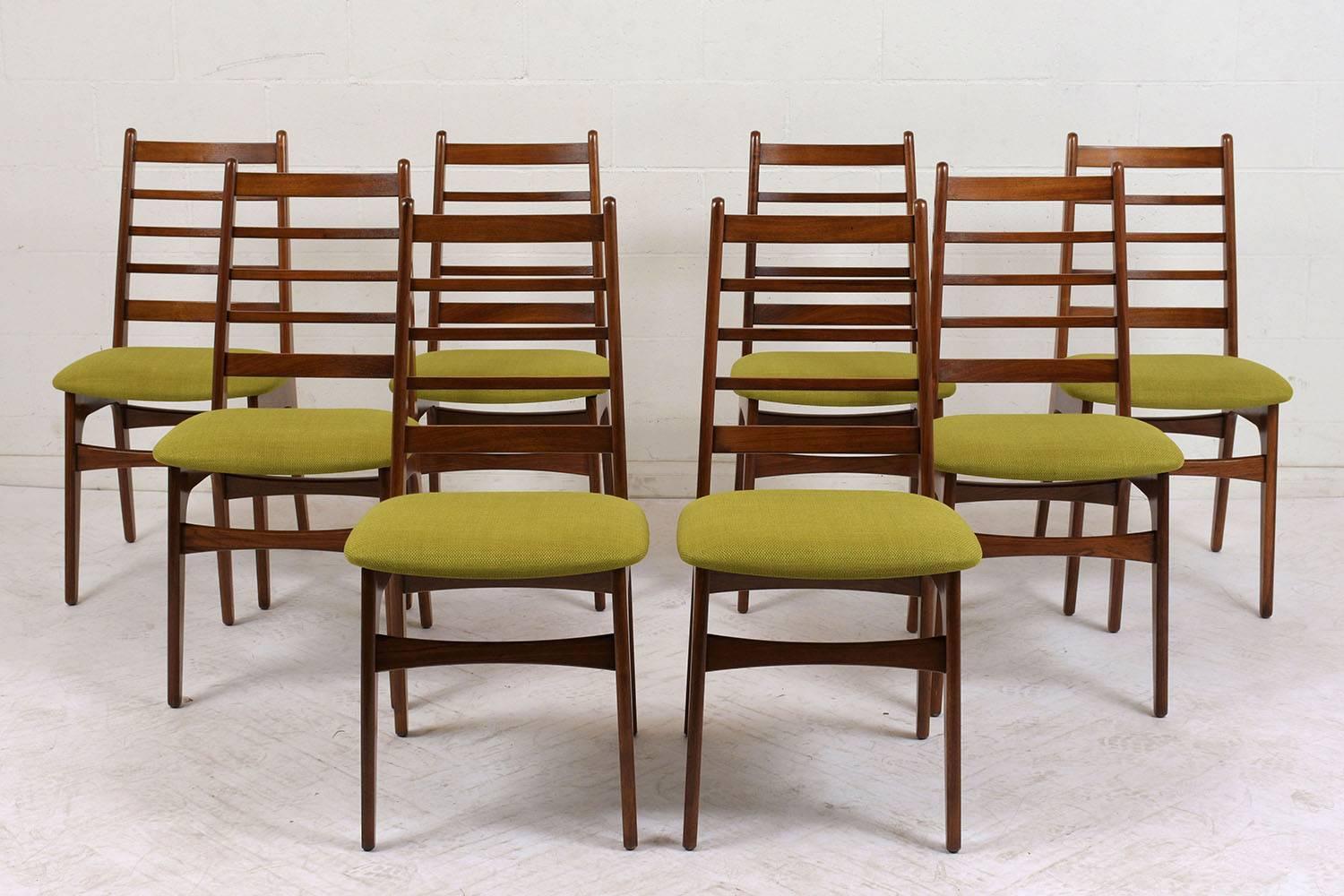 This Set of Eight 1960's Danish Mid-Century Modern Dining Chairs have been completely restored, made out of solid teak wood and has a newly lacquered finish. The chairs feature a high back profile with a ladder design and have been newly upholstered