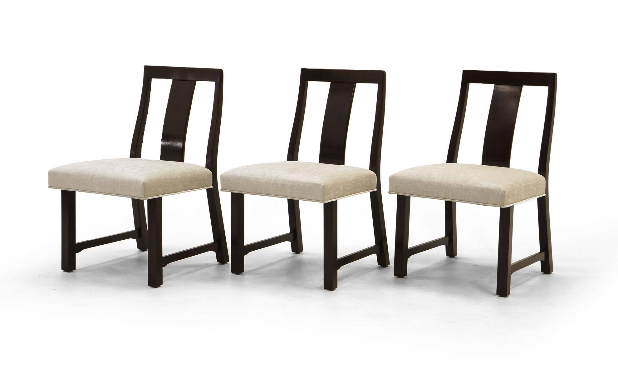 Set of eight dining chairs designed by Edward Wormley for Dunbar. Dark stained African mahogany with original finish. Expertly reupholstered using luxurious Knoll Chalk fabric, cream / ivory color. A stunning set. Two arm chairs and six side