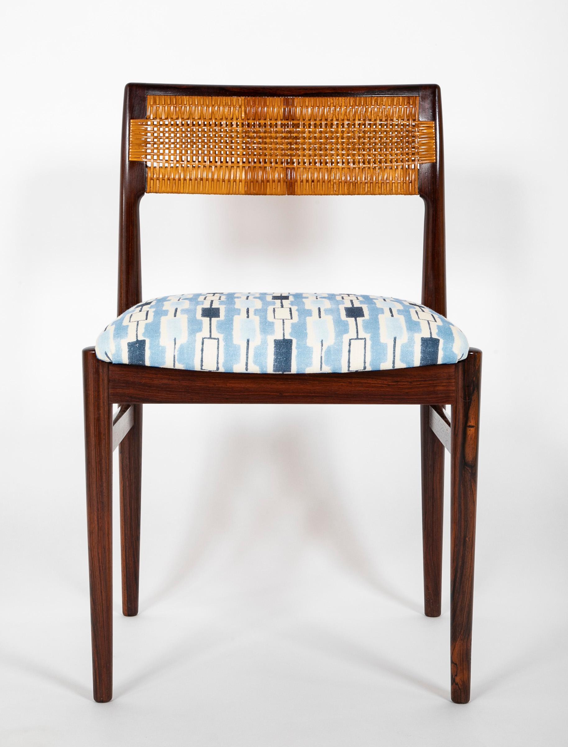 A handsome set of eight (8) rosewood dining chairs with caned backrest by Erik Wortz (Danish. 1916 - 1997). Denmark. Mid-20th century.