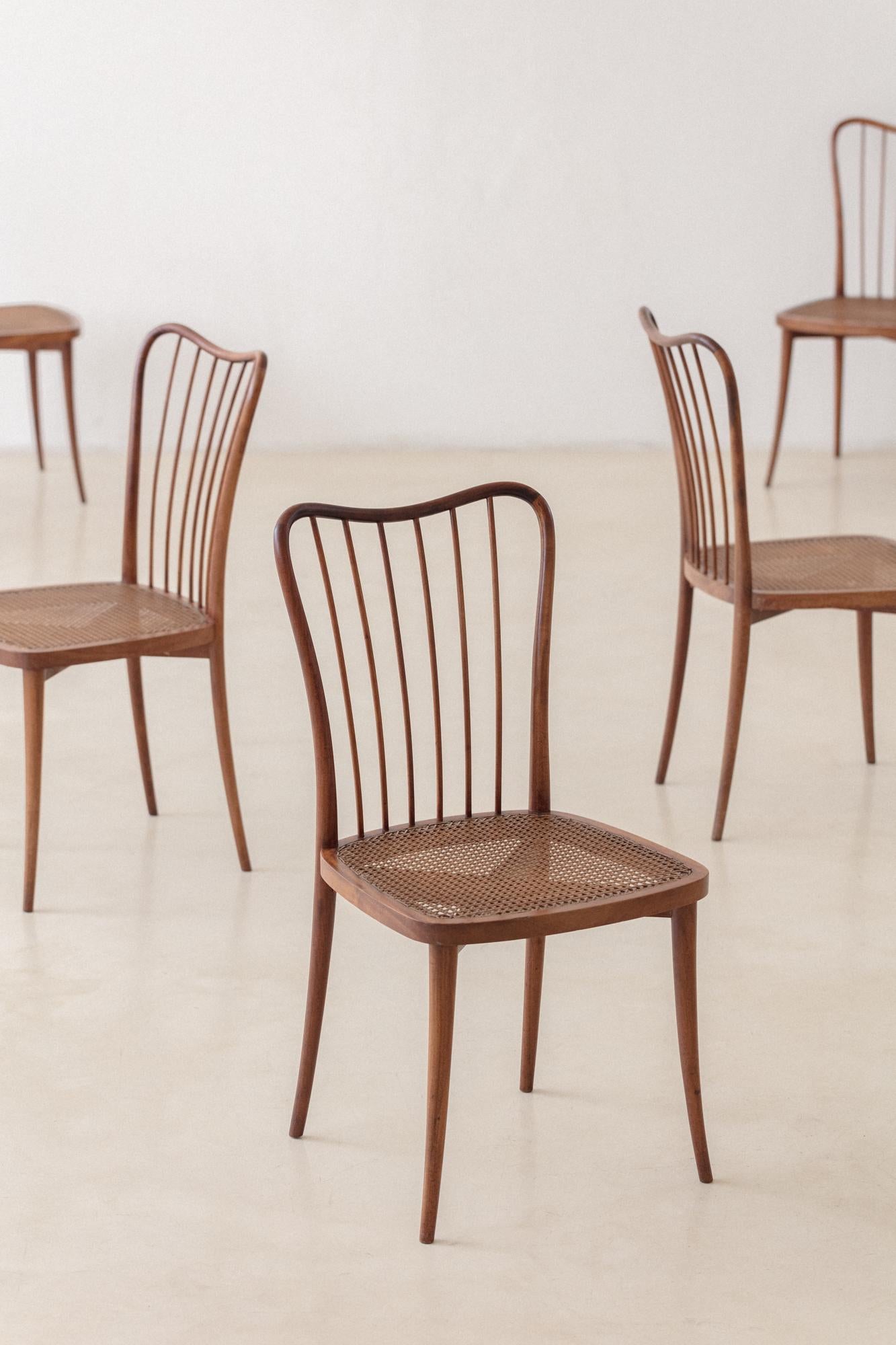 This set of eight exquisitely crafted Cane chairs in Amendoim Wood, designed by Joaquim Tenreiro (1906-1992) in the 1960s, is a gorgeous example of his mastery of technical and constructive solutions and an aesthetic experience based on