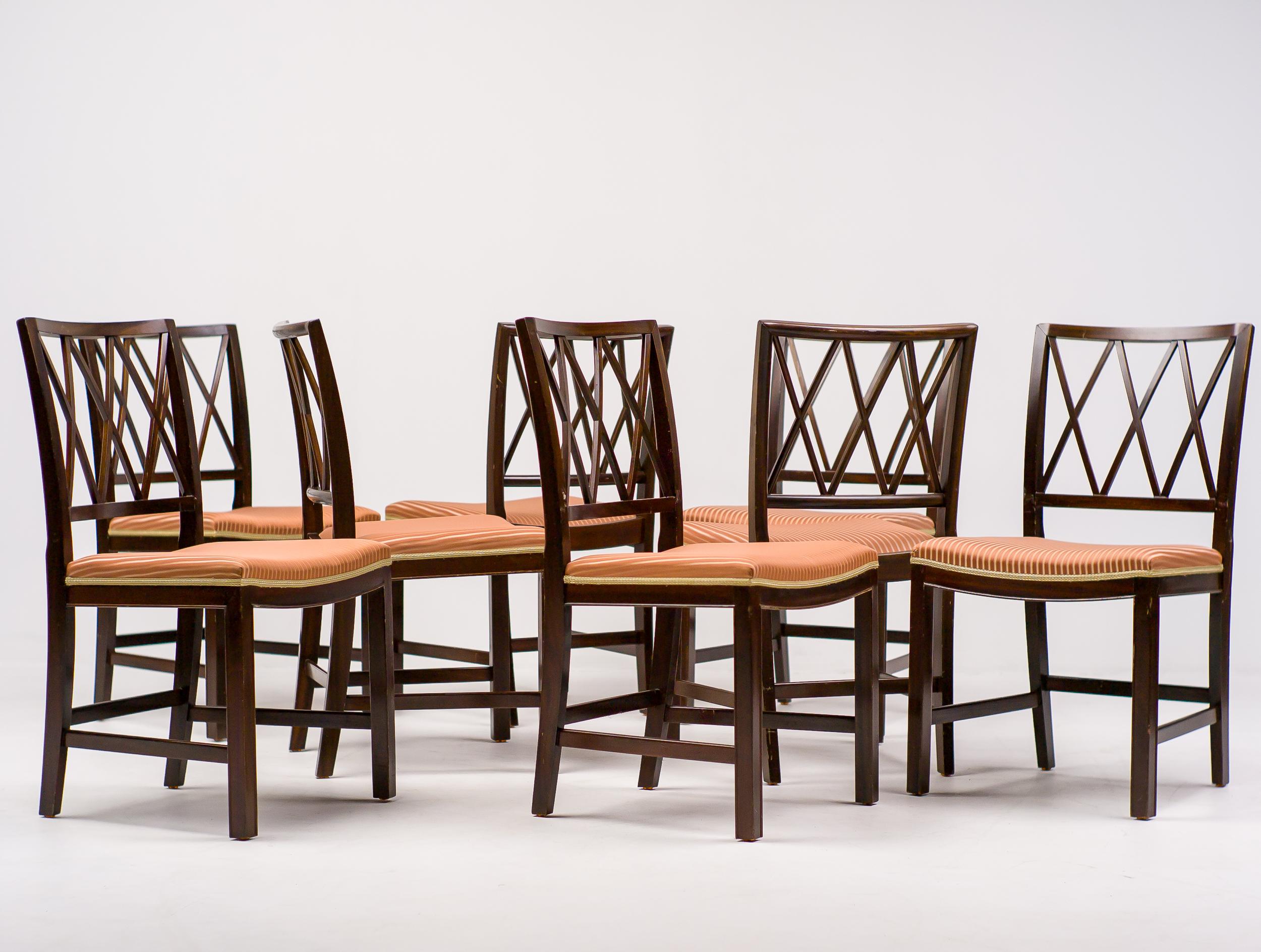 A beautiful matching set of eight Ole Wanscher dining chairs upholstered in original striped fabric. Frame made in dark stained mahogany. Unrestored all original condition with some wear to the finish. These chairs show the great craftsmanship and