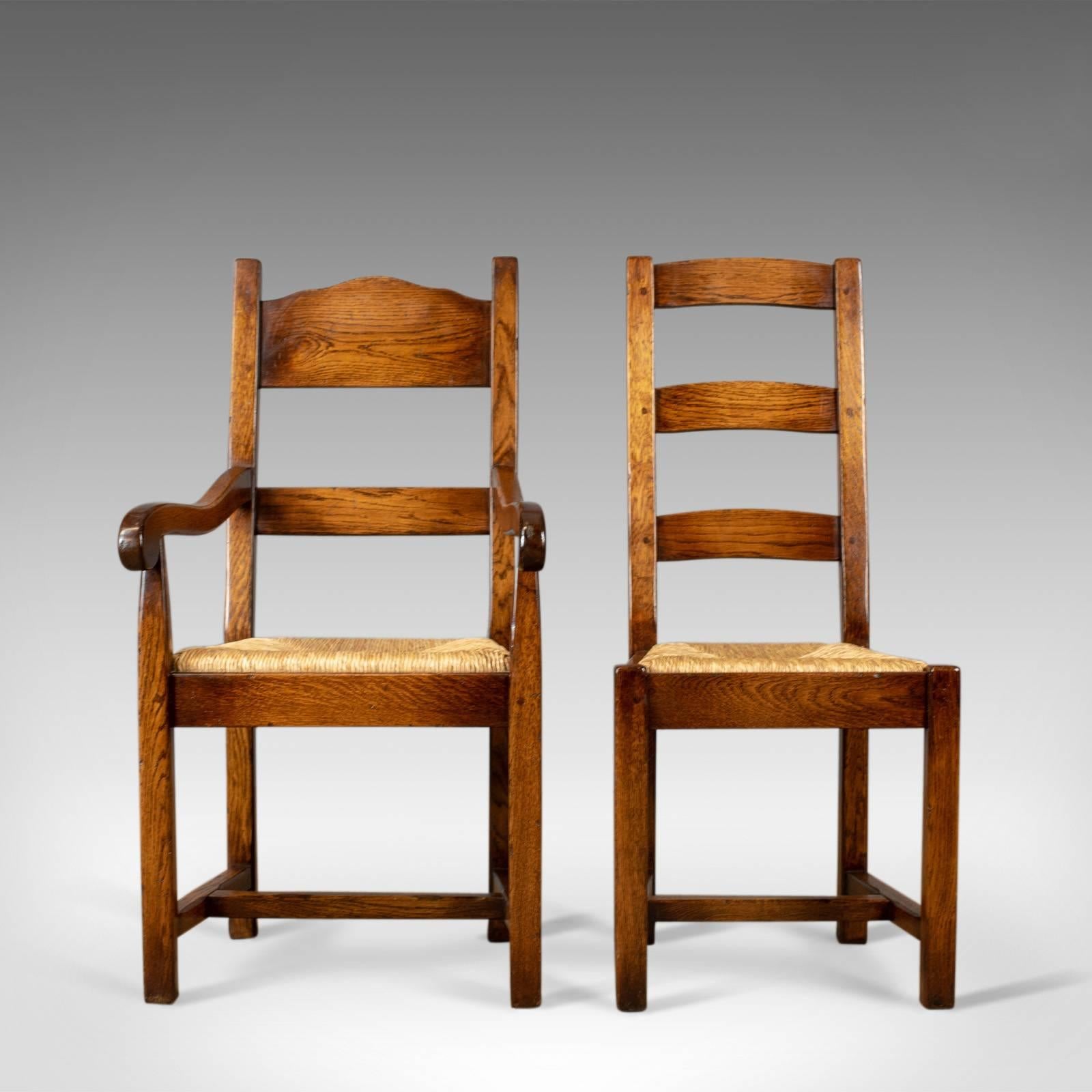 This is a set of eight dining chairs, 20th century English oak in the Victorian taste with rush seats. In a desirable combination benefiting from two carvers and six standard chairs.

Of quality craftsmanship in inch and three-quarter