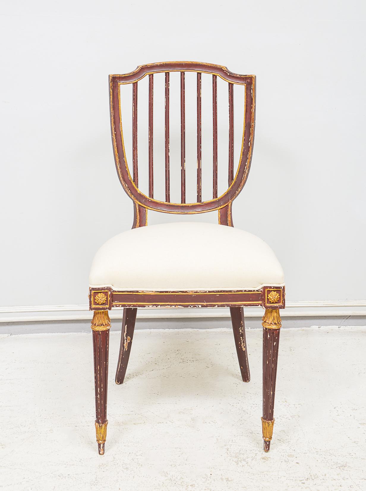 Set of Eight Dining Chairs in the neoclassic manner - chairs are hand-painted and gilded with fluted legs and shield-backs - very comfortable. 