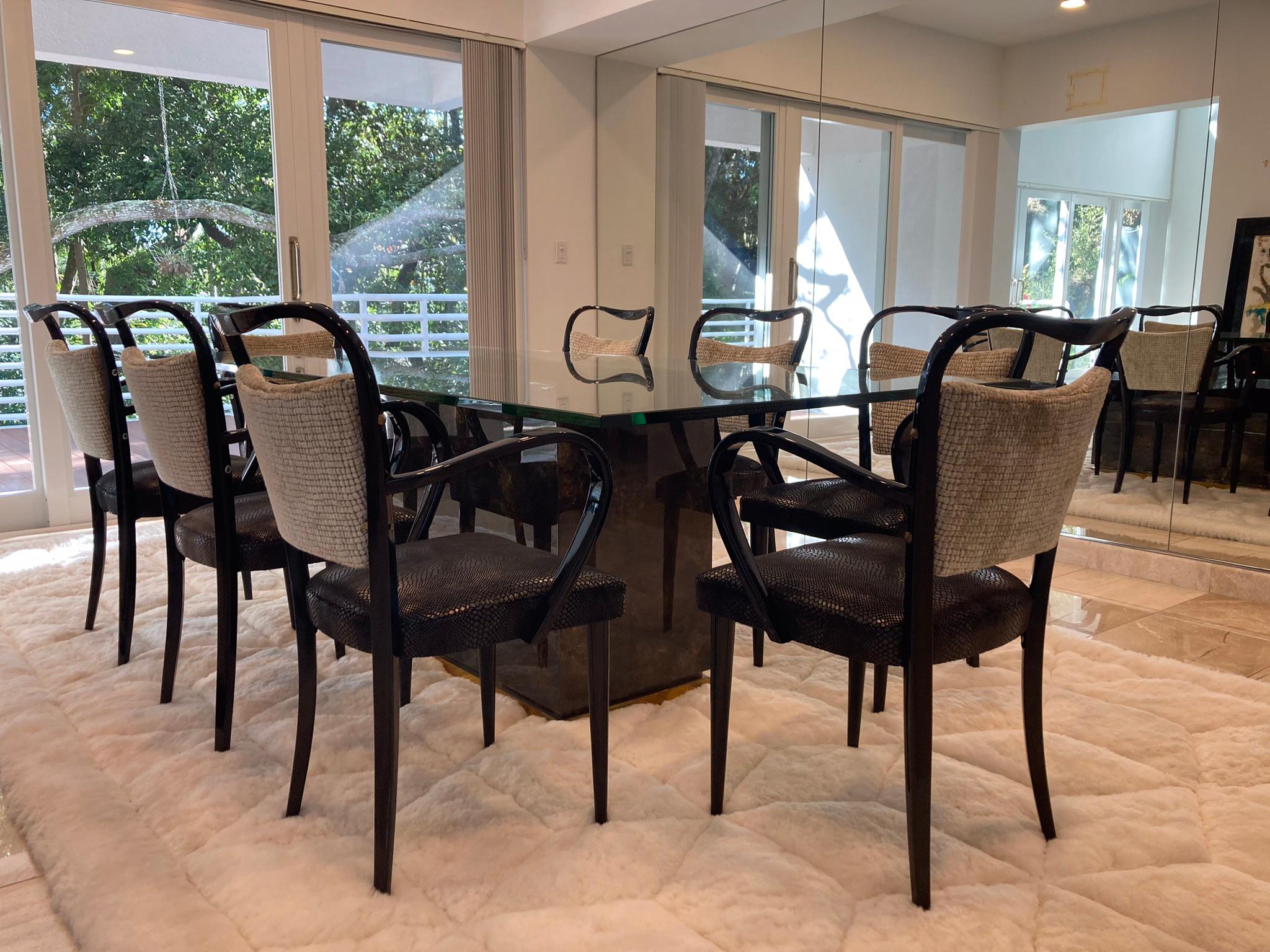 Beautiful set of eight dining chairs from the 1950s made in Italy. Black painted wood with brass hardware. Seats and backs in fabric. Ready for a new home.