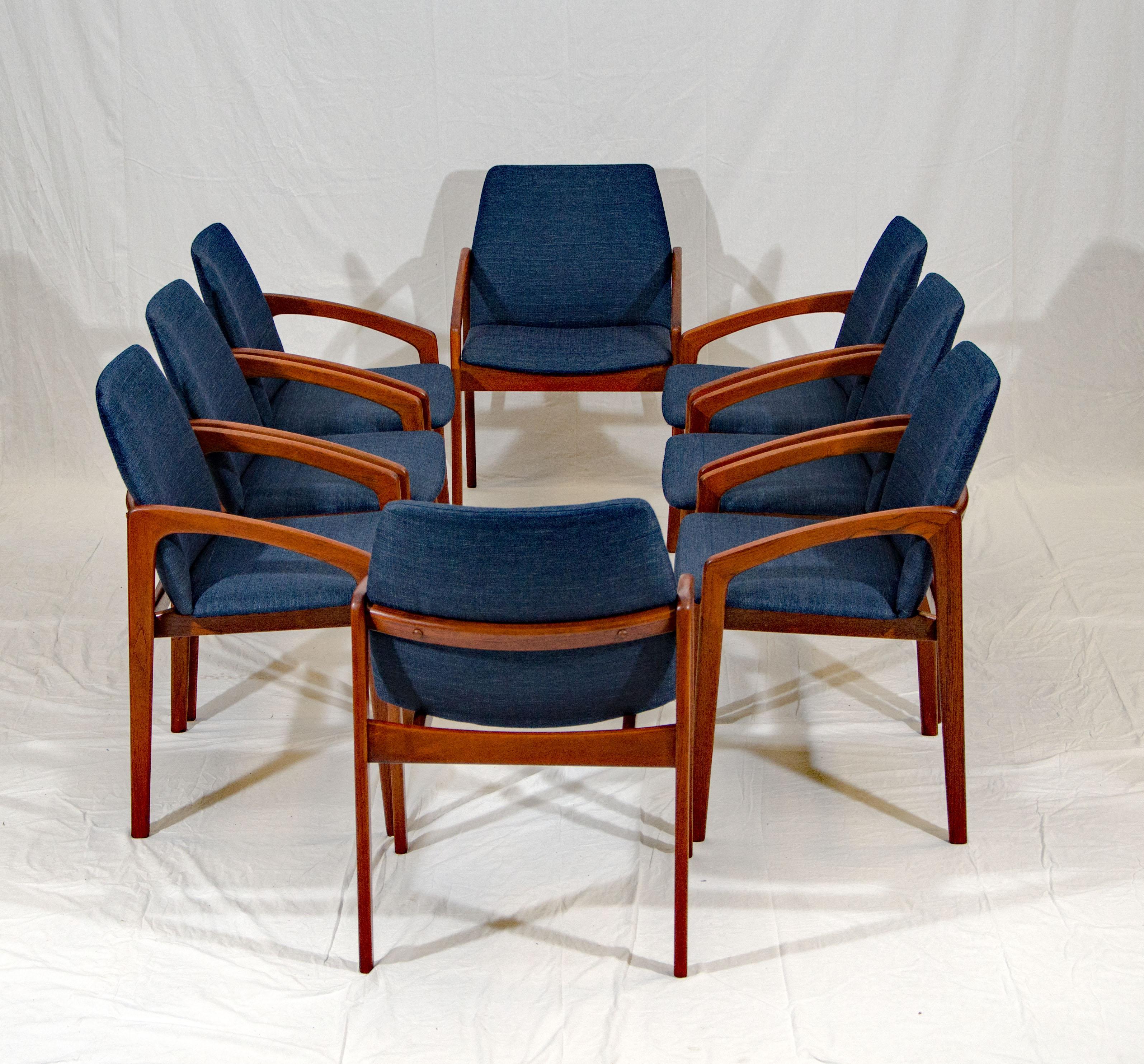 Beautiful set of eight dining chairs with sloping armrests designed by Henning Kjærnulf and manufactured by Korup Stolefabrik. They will provide very comfortable seating for you and your guests with upholstered seats and canted upholstered backs.