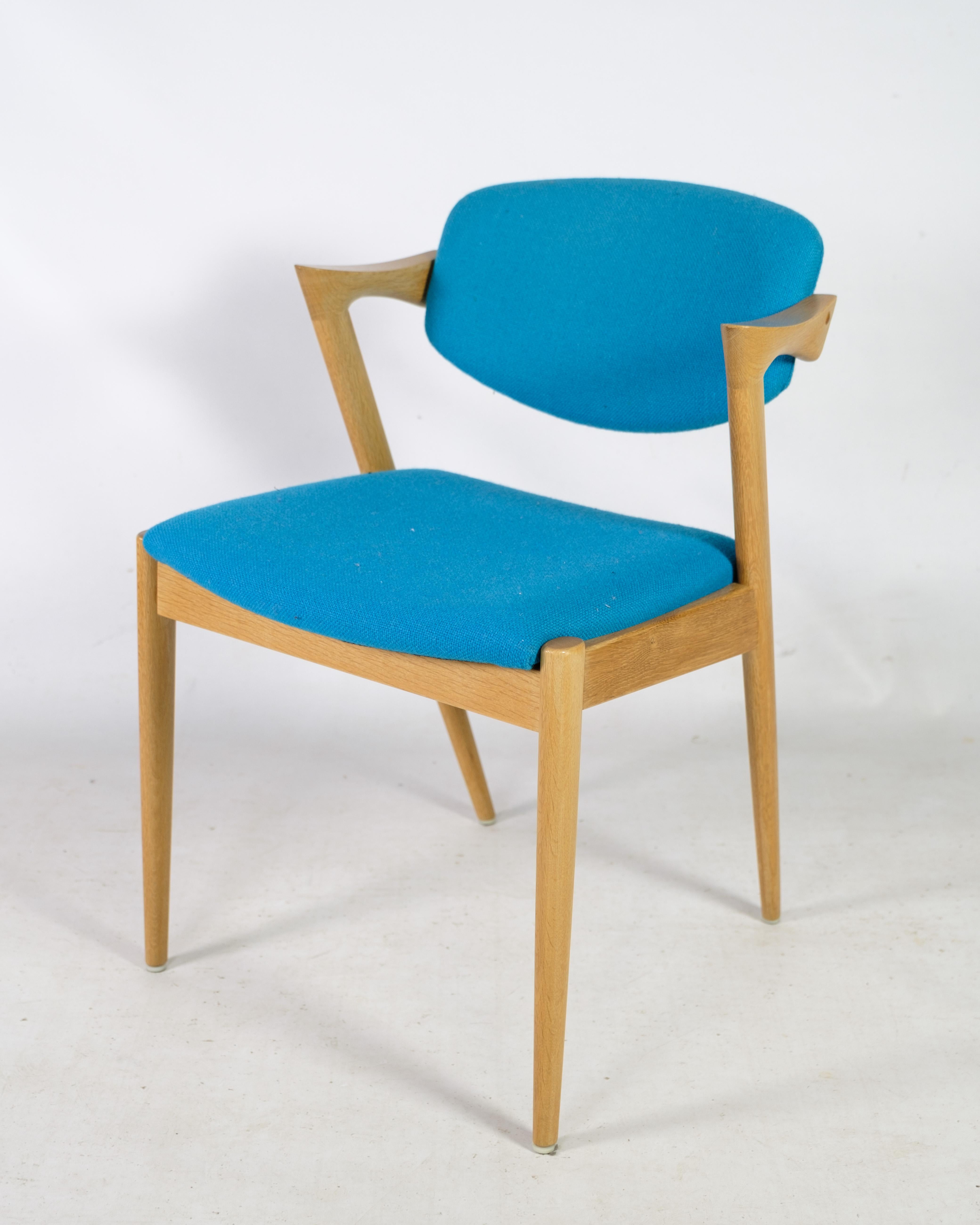 This set of 8 dining chairs is truly an iconic example of the timeless elegance that characterizes Danish furniture design from the Mid-20th Century. The chairs are model 42, designed by the renowned Danish designer Kai Kristiansen and manufactured