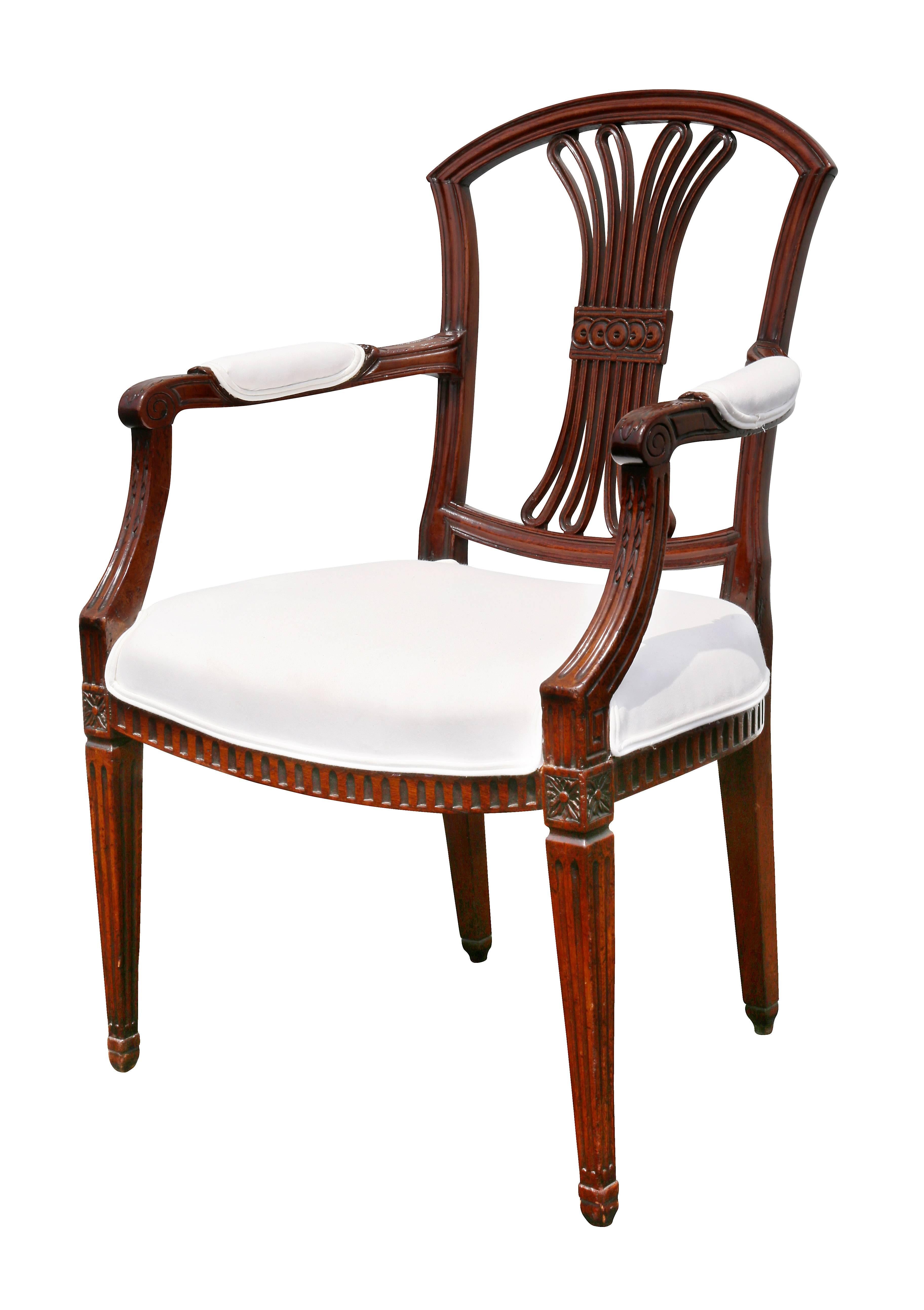 Each with an arched back with central pierced splat over a shaped seat raised on square tapered fluted legs headed by paterae. Comprising six sides and two armchairs.