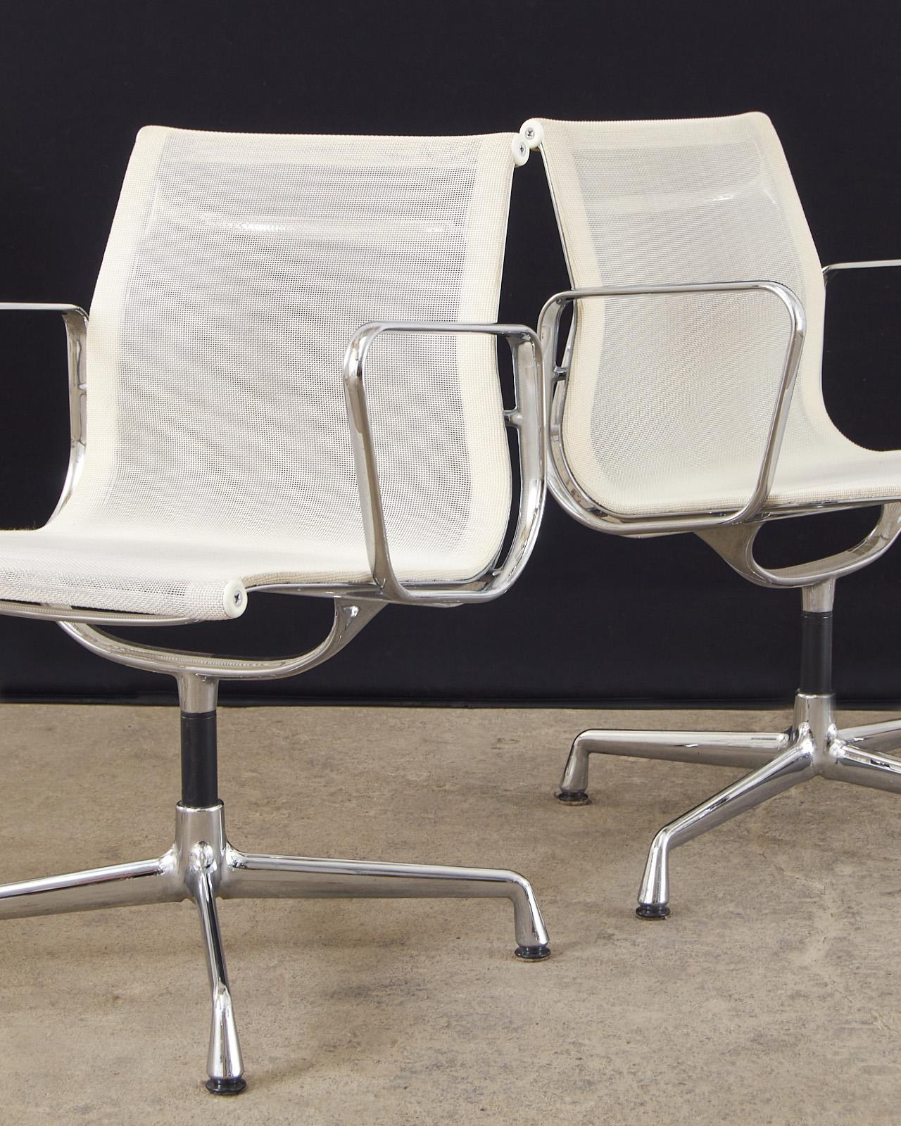 Chic set of eight armchairs designed in the 50s by Charles and Ray Eames for Herman Miller. Authorized and produced today in Switzerland by Vitra model number EA 108. The chairs feature a highly polished cast aluminium frame with a chrome finish.