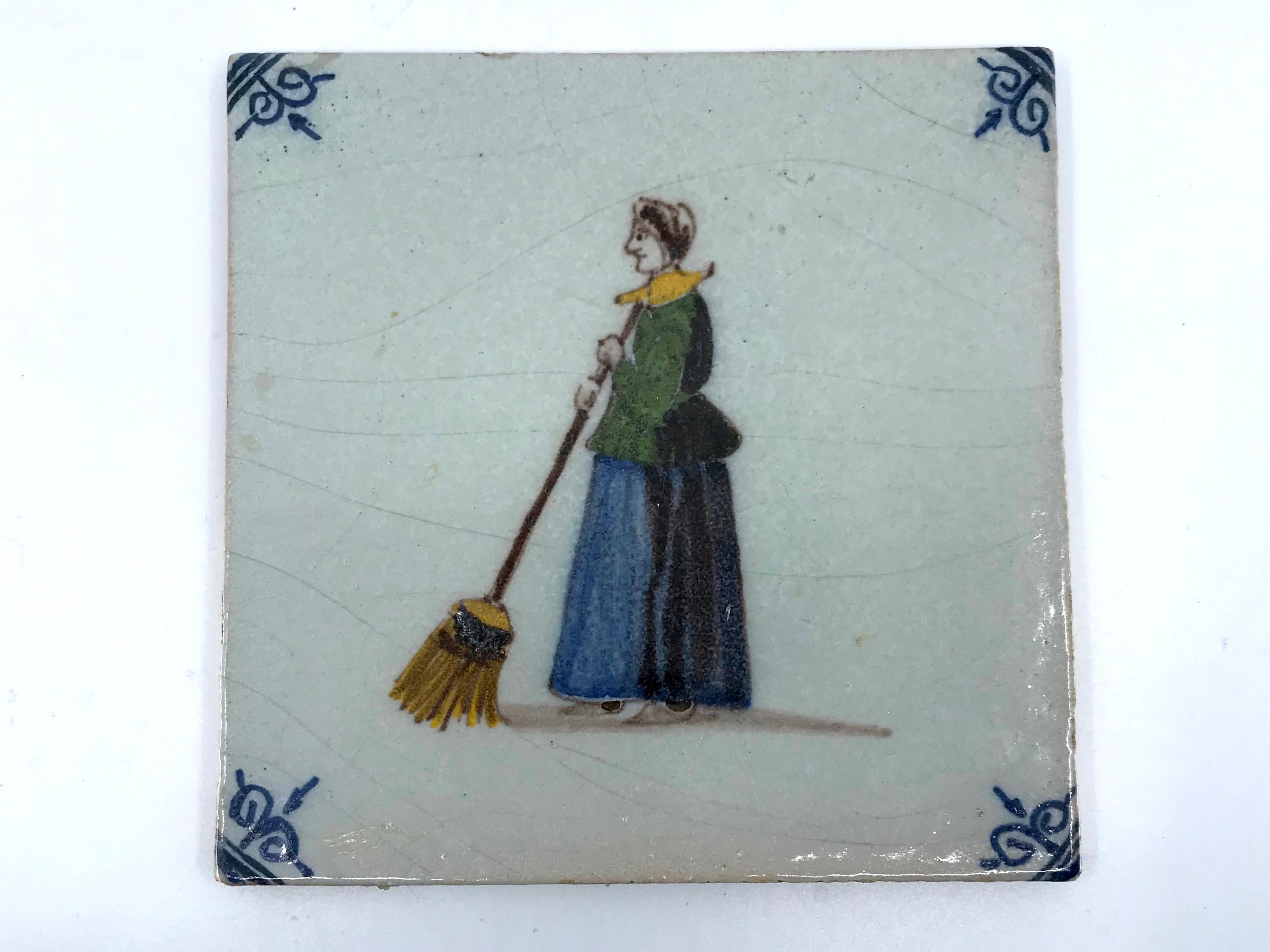 Set of eight early 19th c Dutch tiles. Eight blue and white square tiles with hand painted depictions of the tradespeople of Holland in eight unique tiles including: fishermen, milkmaid, sweeper, town crier and dyke repairer etc in gold yellow and