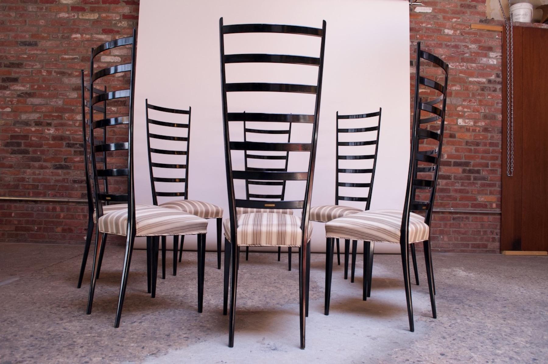 Set of eight sculptural, extra high, ladder-back dining chairs (circa 1950s, Italy) composed of a 7-rung back with upholstered seat. Clean lines and elegant, shapely form. Retains the original black lacquer -- hand-applied, not sprayed. Extremely
